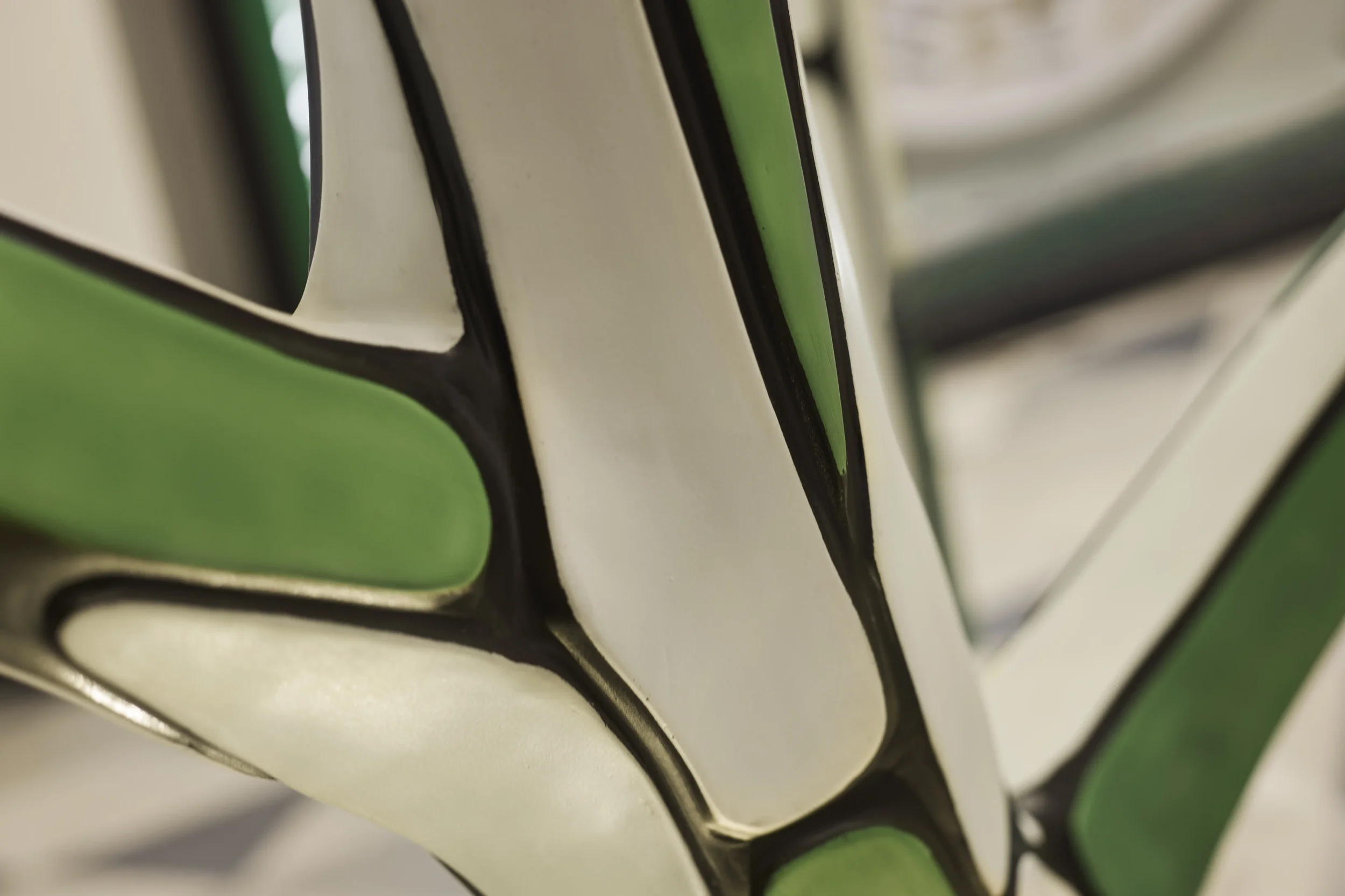 Close-up of a chessboard showing alternating green and cream-colored squares with black borders.