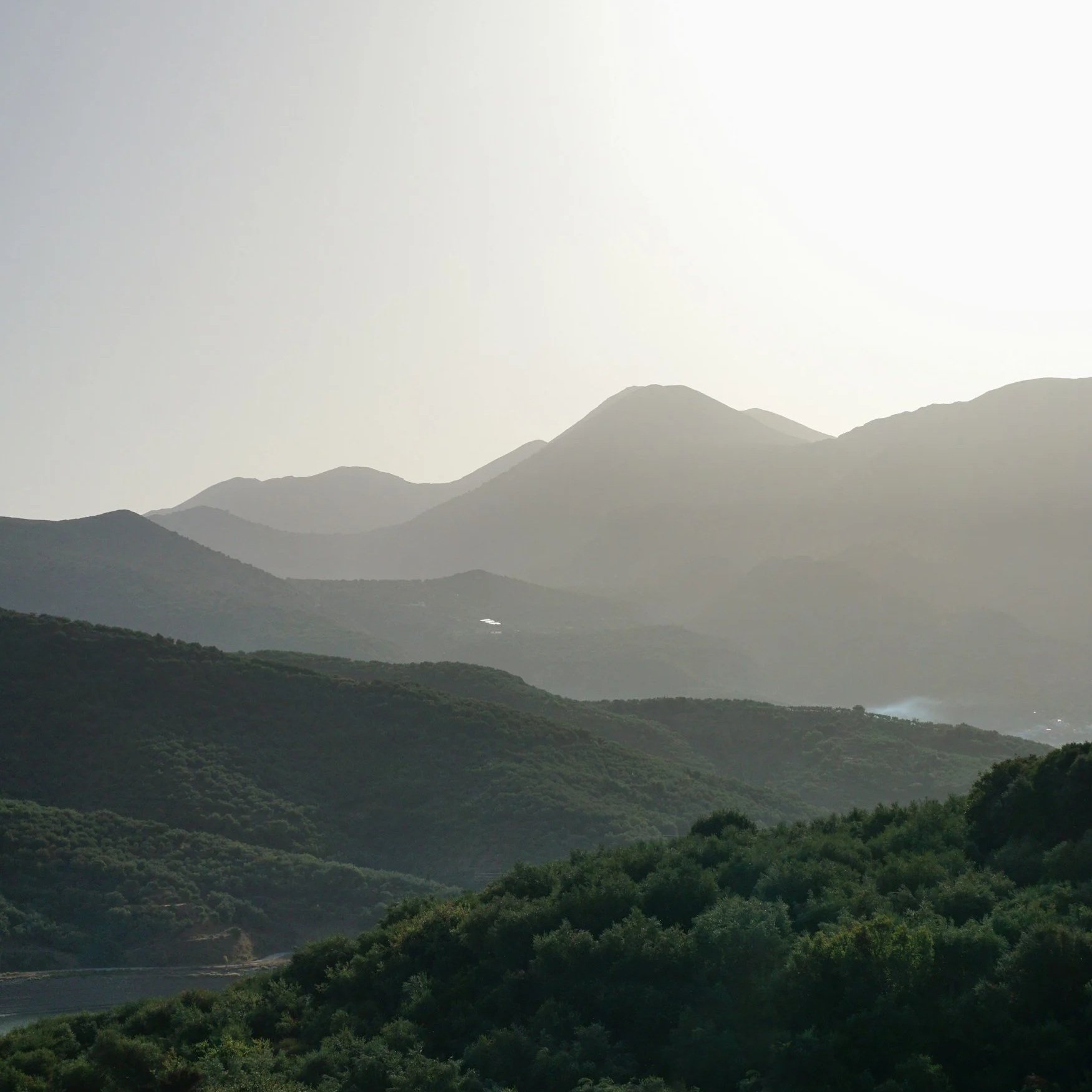Mountains in Crete, layered, getting more hazy in the distance.