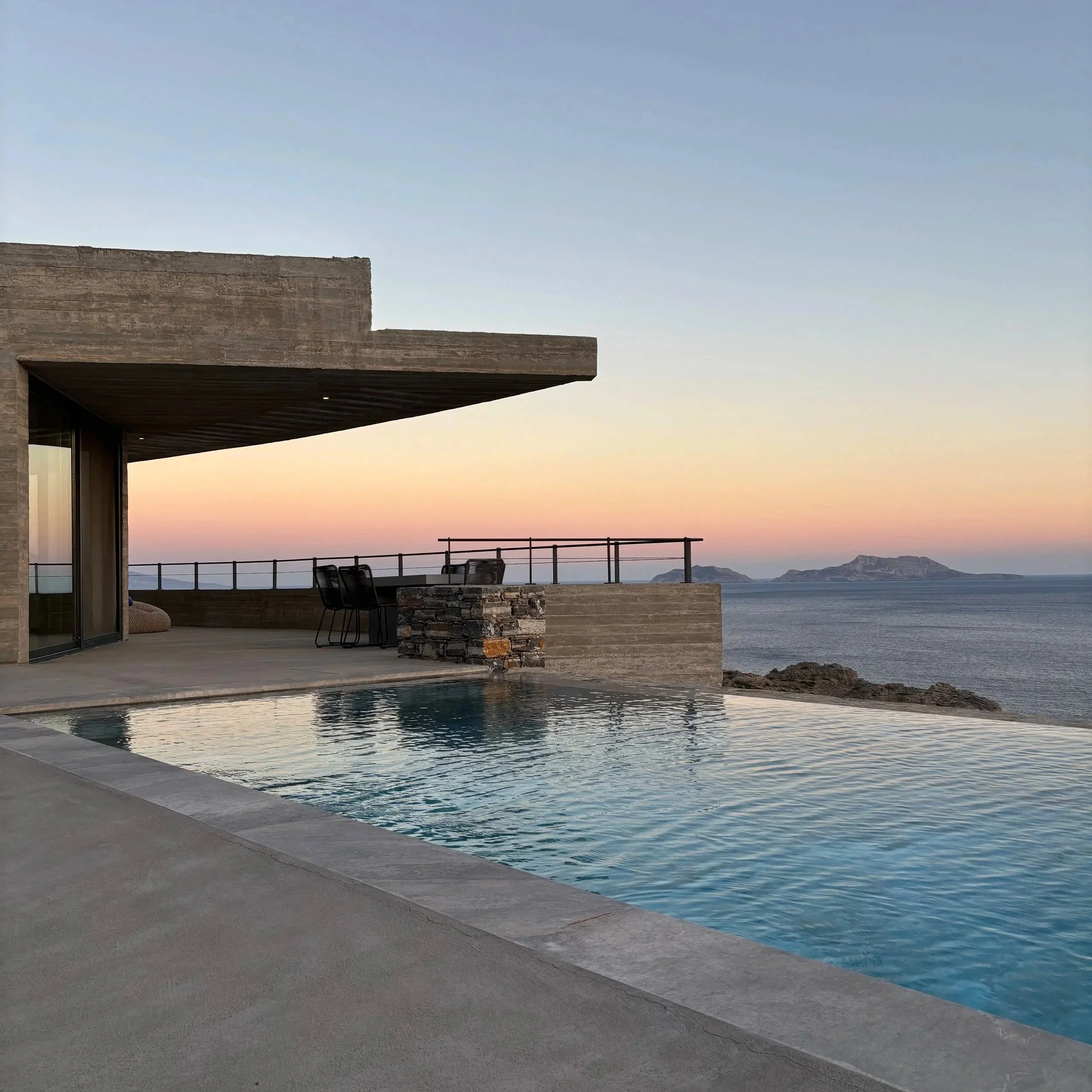 Pool at Villa Eulimene in Agios Pavlos, South Crete, with terrace in the background and Paximadia Islands.
