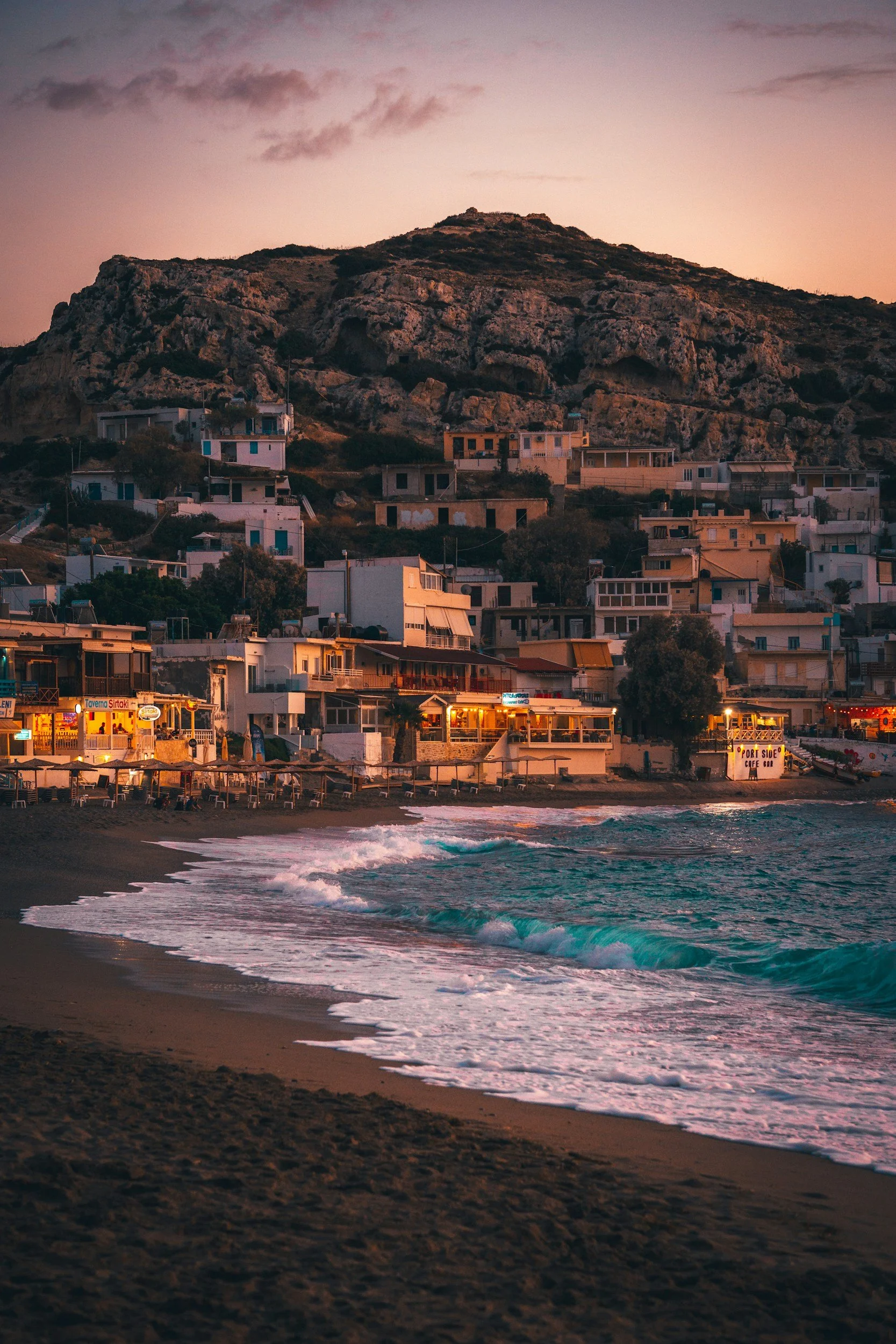 Beach and village of Matala during sunset.