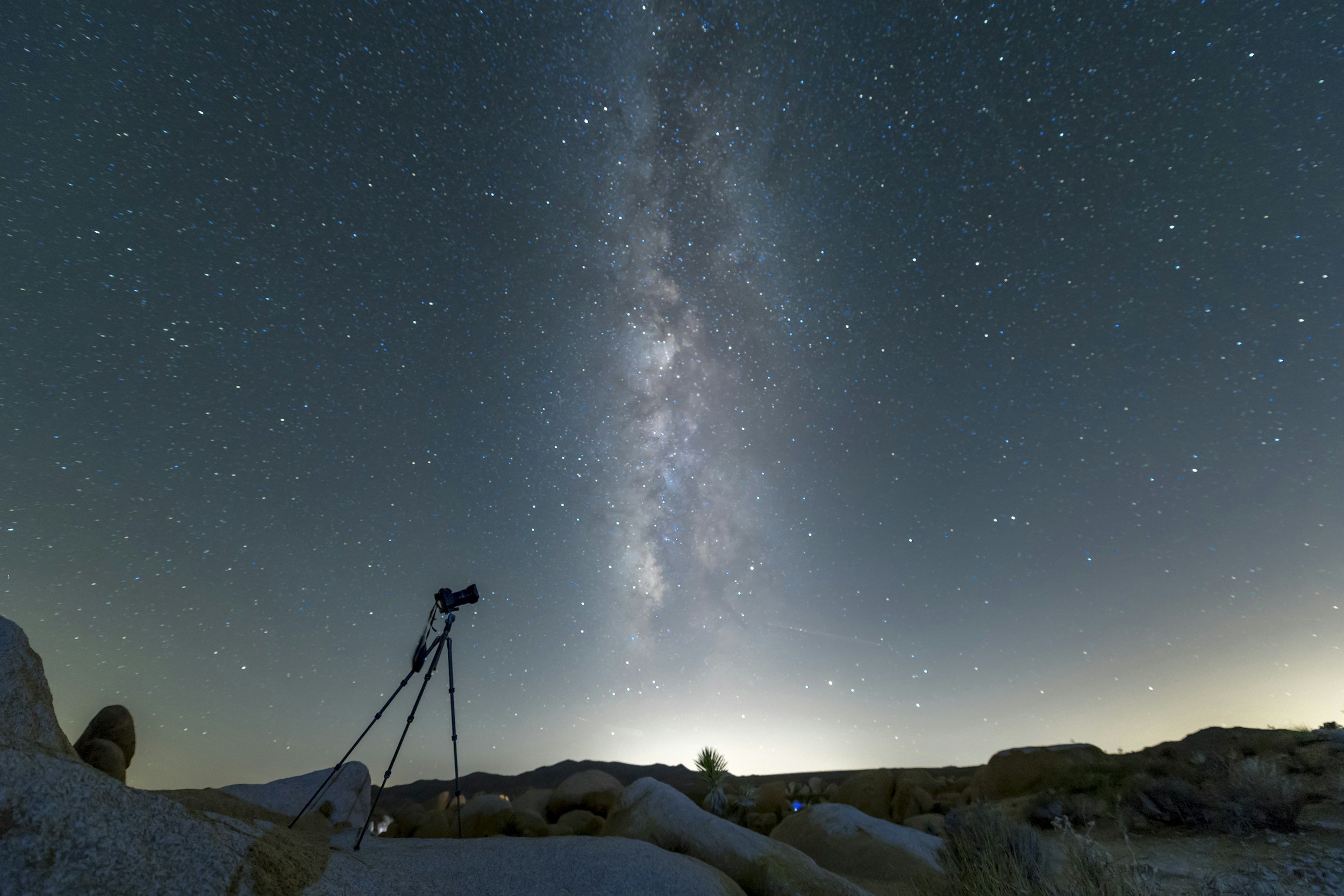 Telescope directed at the milky way in the night sky.
