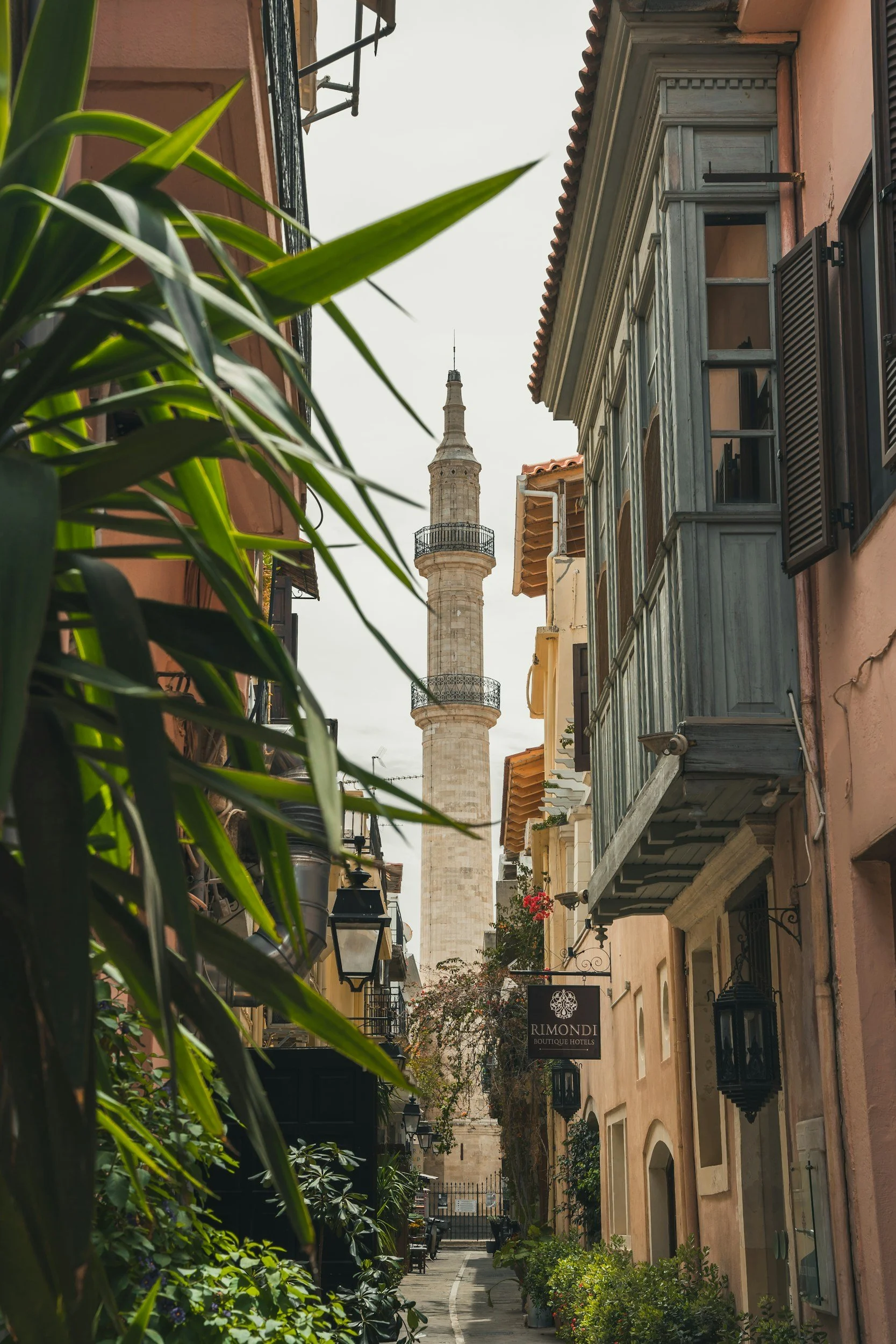 Narrow alley in the Old Town of Rethymno with minaret in the distance.