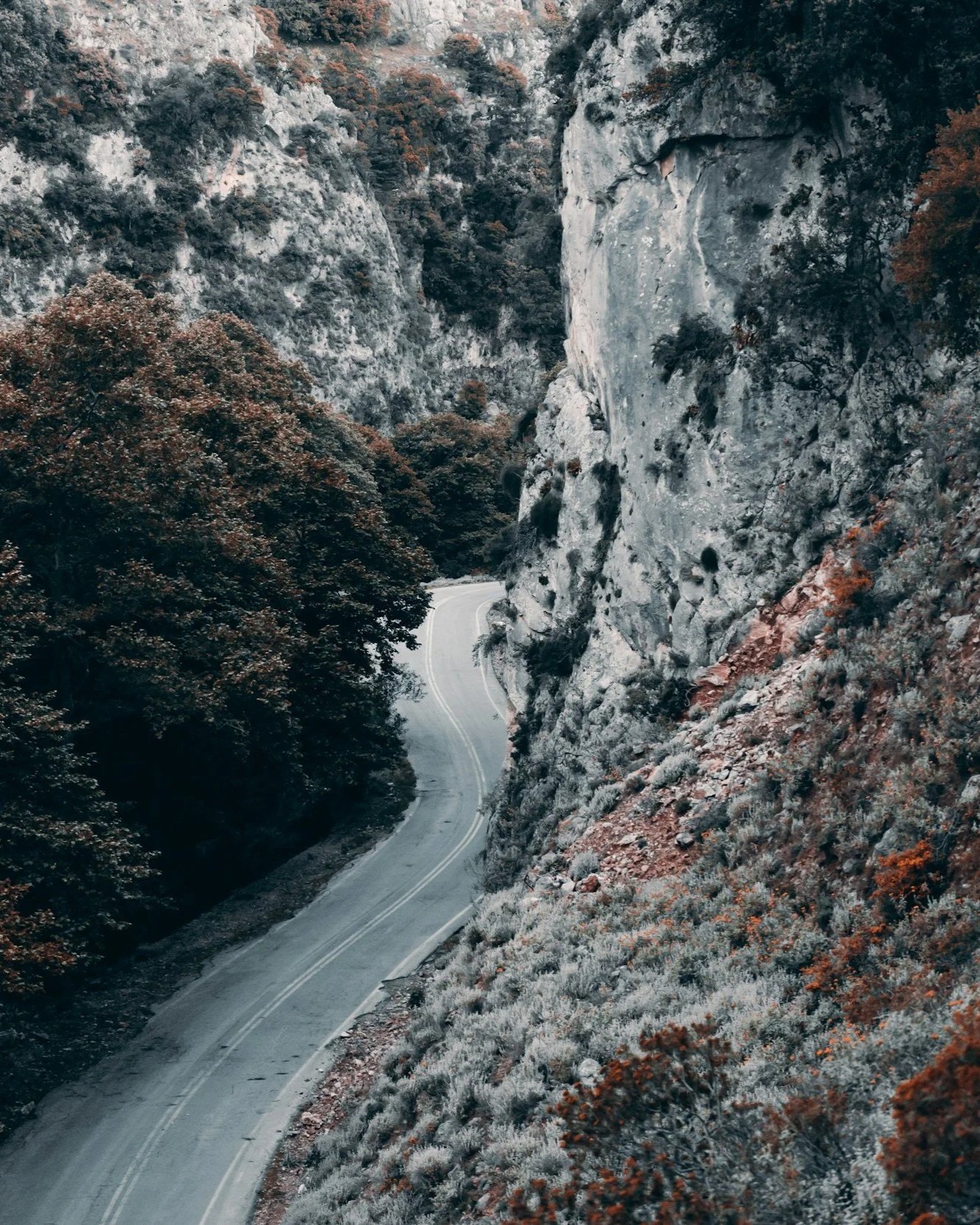 Asphalt road winding through a narrow gorge in Crete.