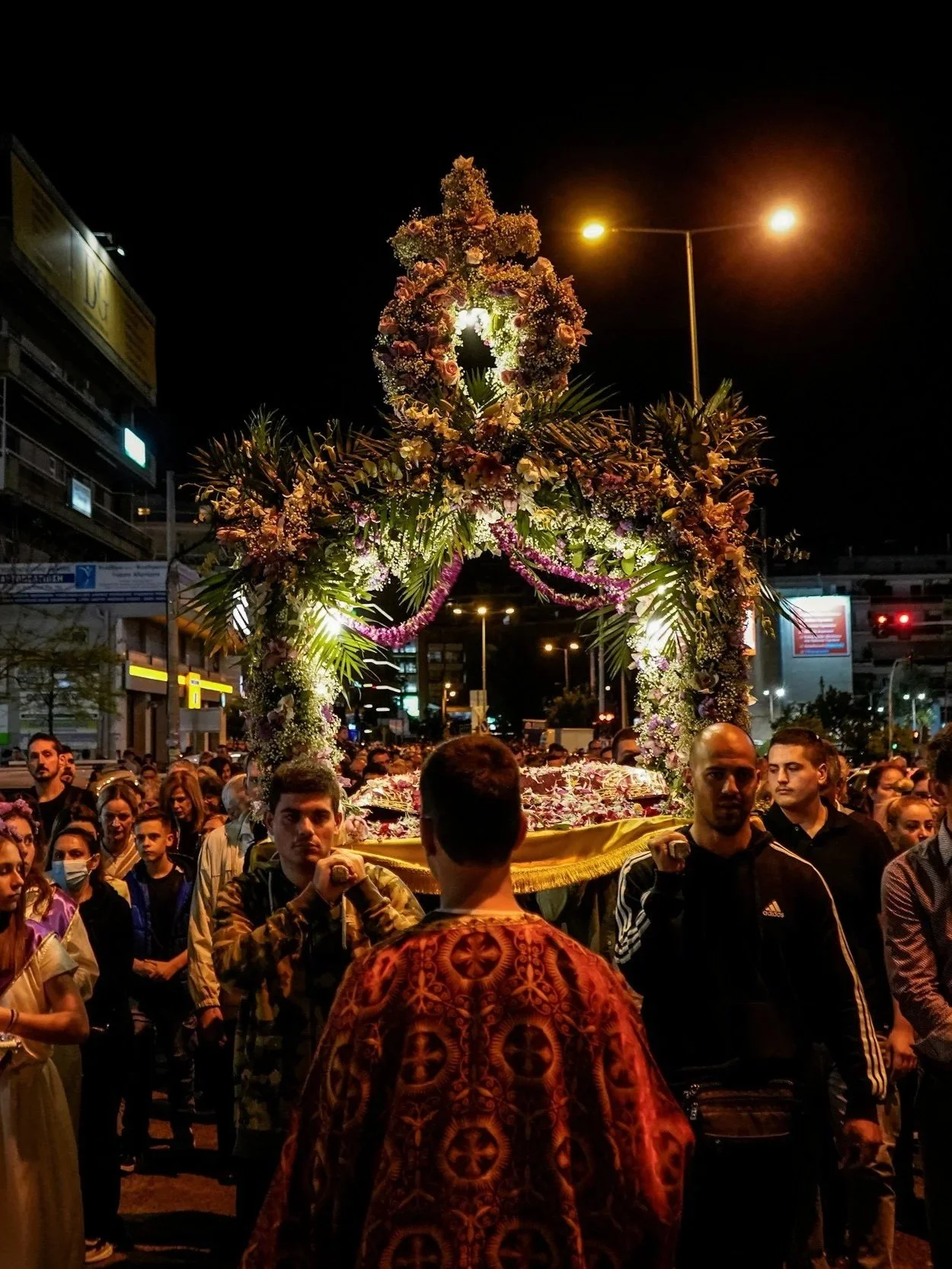 Orthodox Easter procession in Crete, with men carrying the Epitaphios, a decorated bier representing Christ's coffin