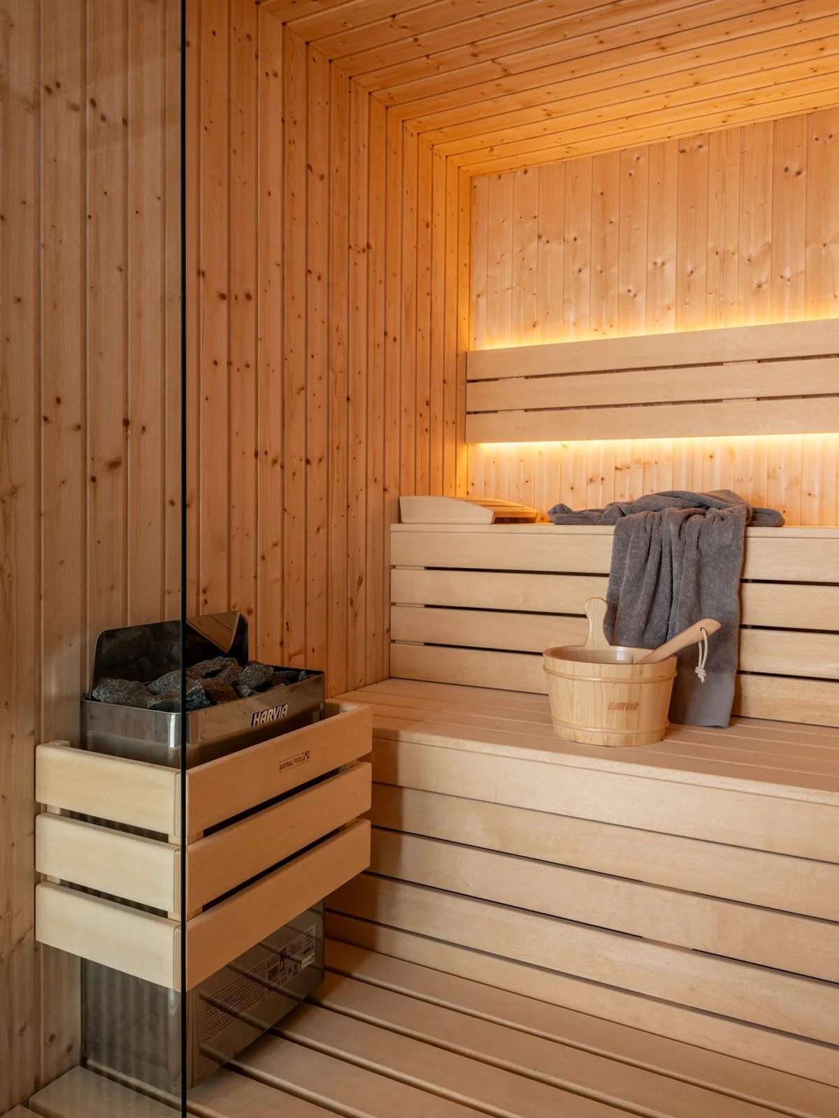 Sauna at villa Keras Cliff House in South Crete, warm light, towels hanging gently from the sauna bench.