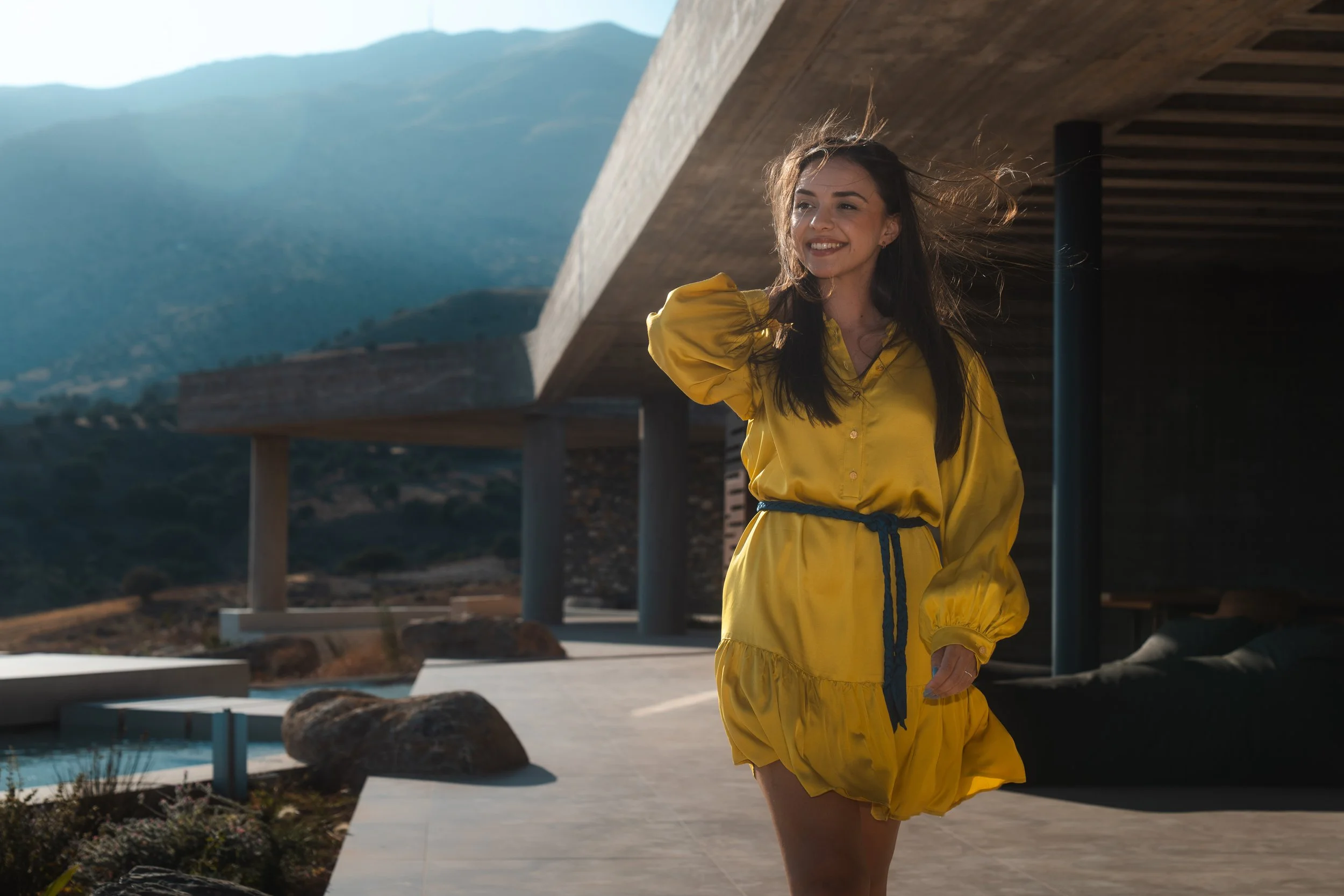 Woman on a terrace at Keras Cliff House, a luxury villa in South Crete, with mountain views and coastal breeze.