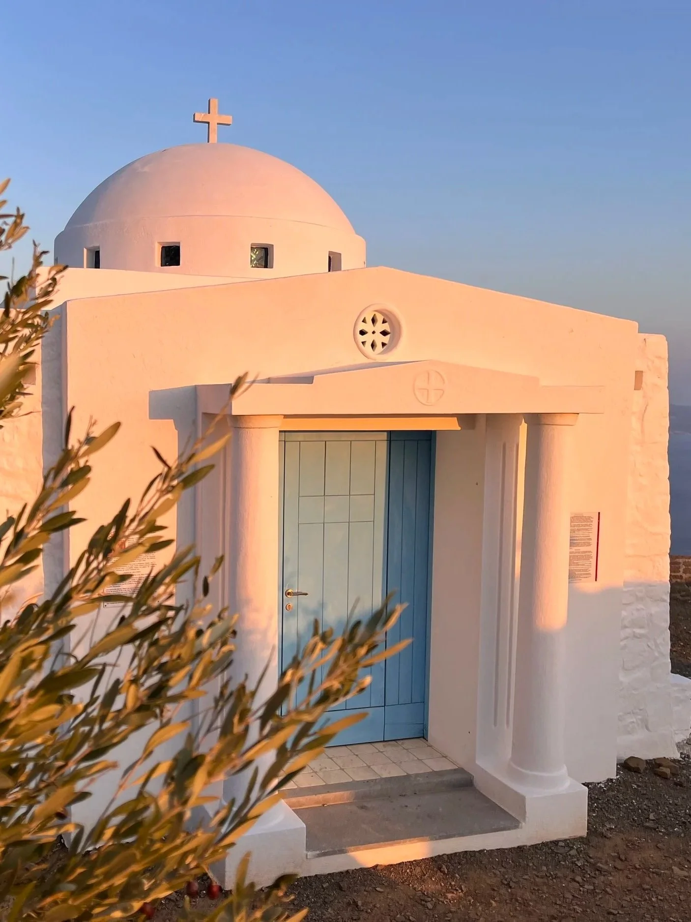 White facade of the Church of Analipsi, Melambes, South Crete, turns pink during sunset.