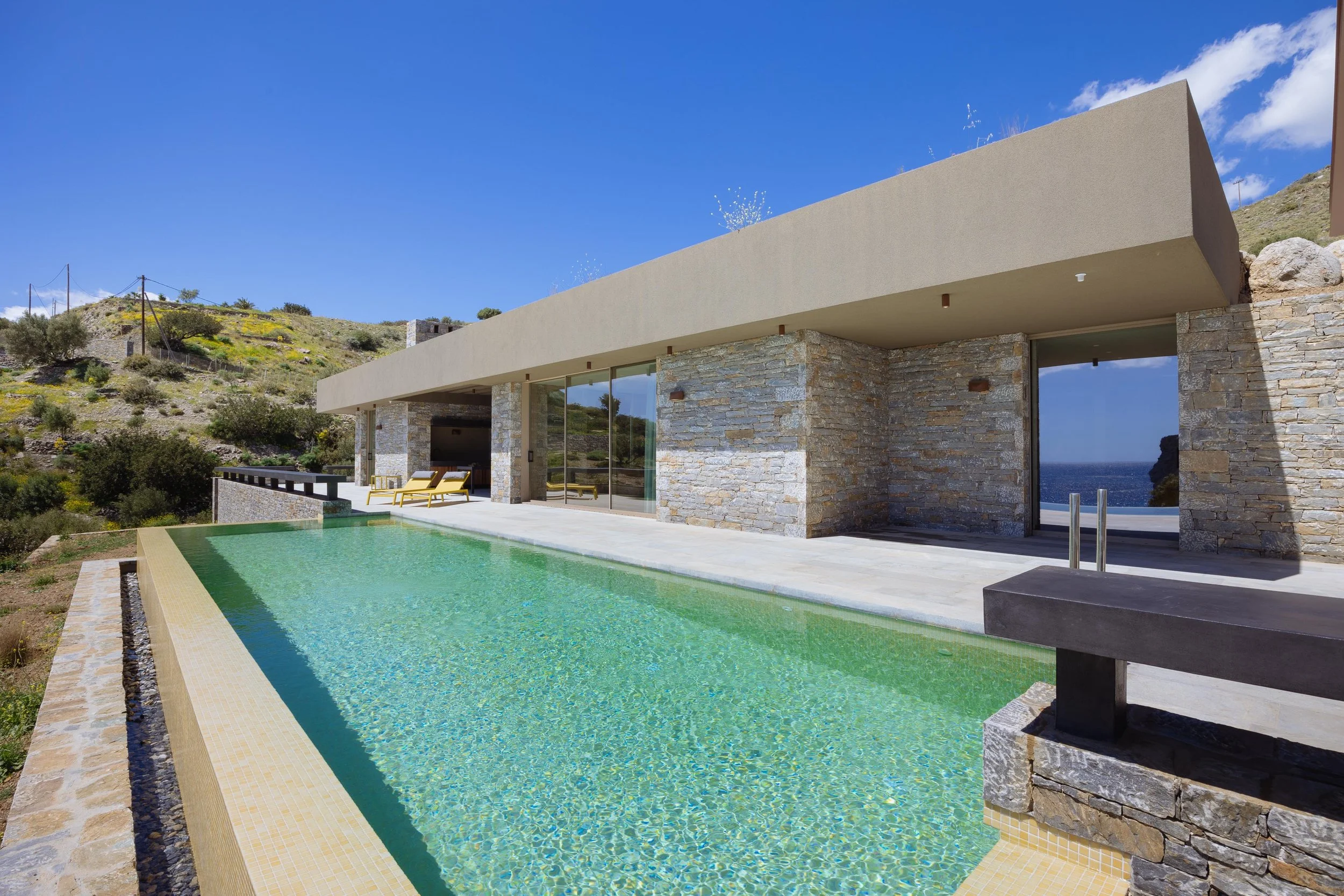 Villa SeaCrete in South Crete featuring a long infinity pool and minimalist design that blends into the natural coastal landscape.