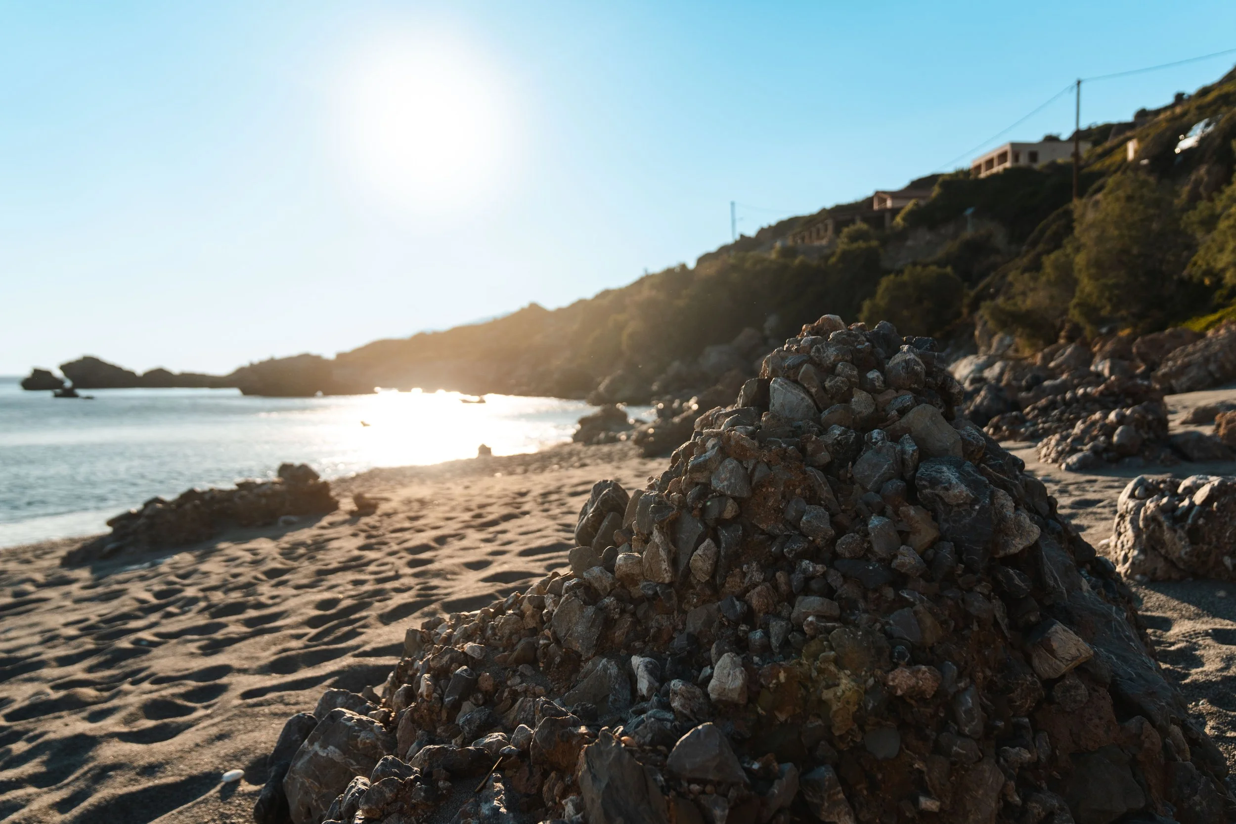 Stones at a sand beach in Crete during summer.