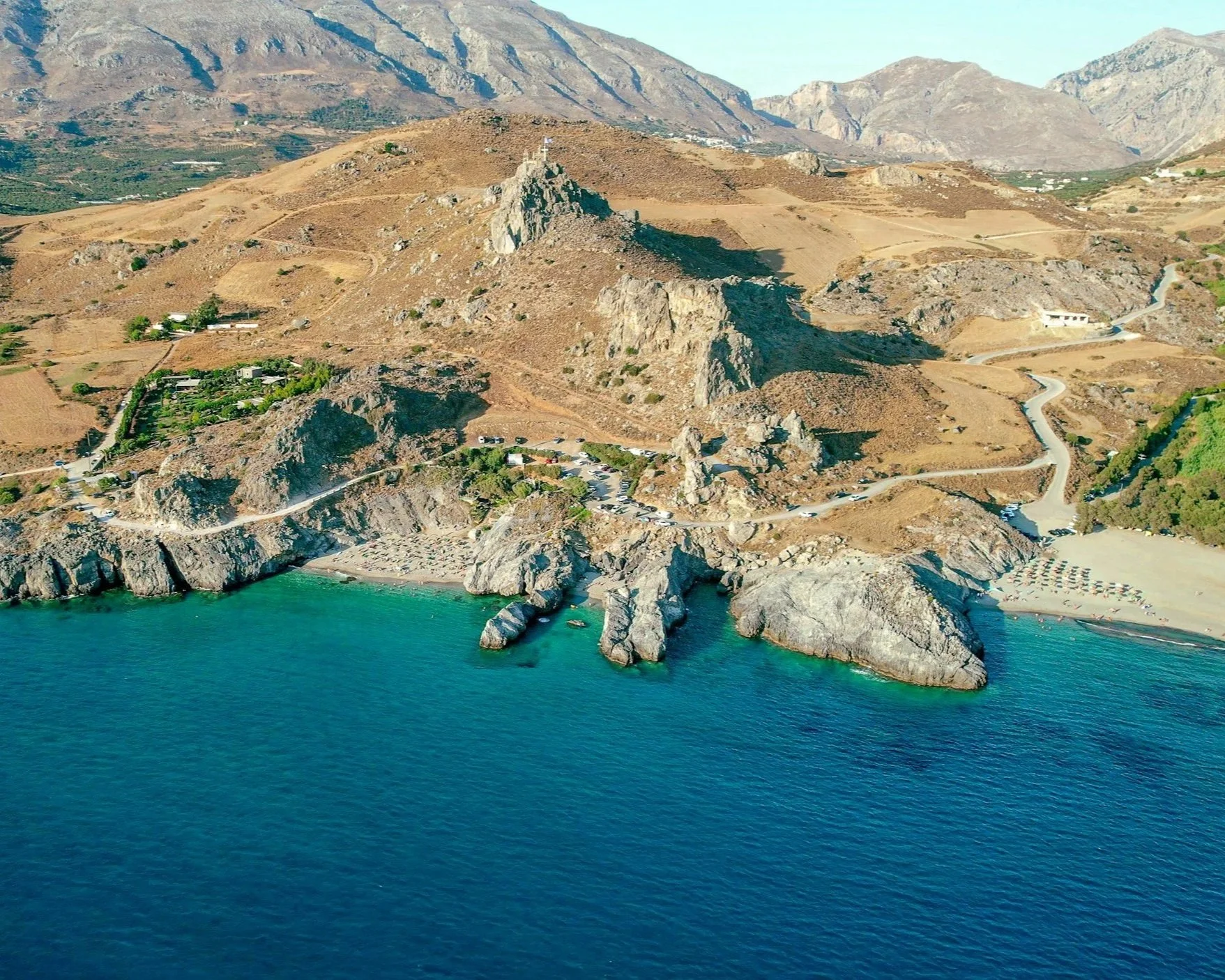 Coastline in South Crete with beaches, turquoise water and mountains.