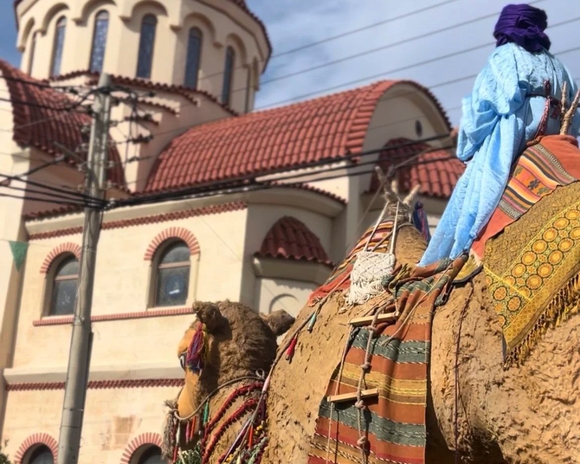 Camel float with camel rider in front of a church during Rethymno Carnival.