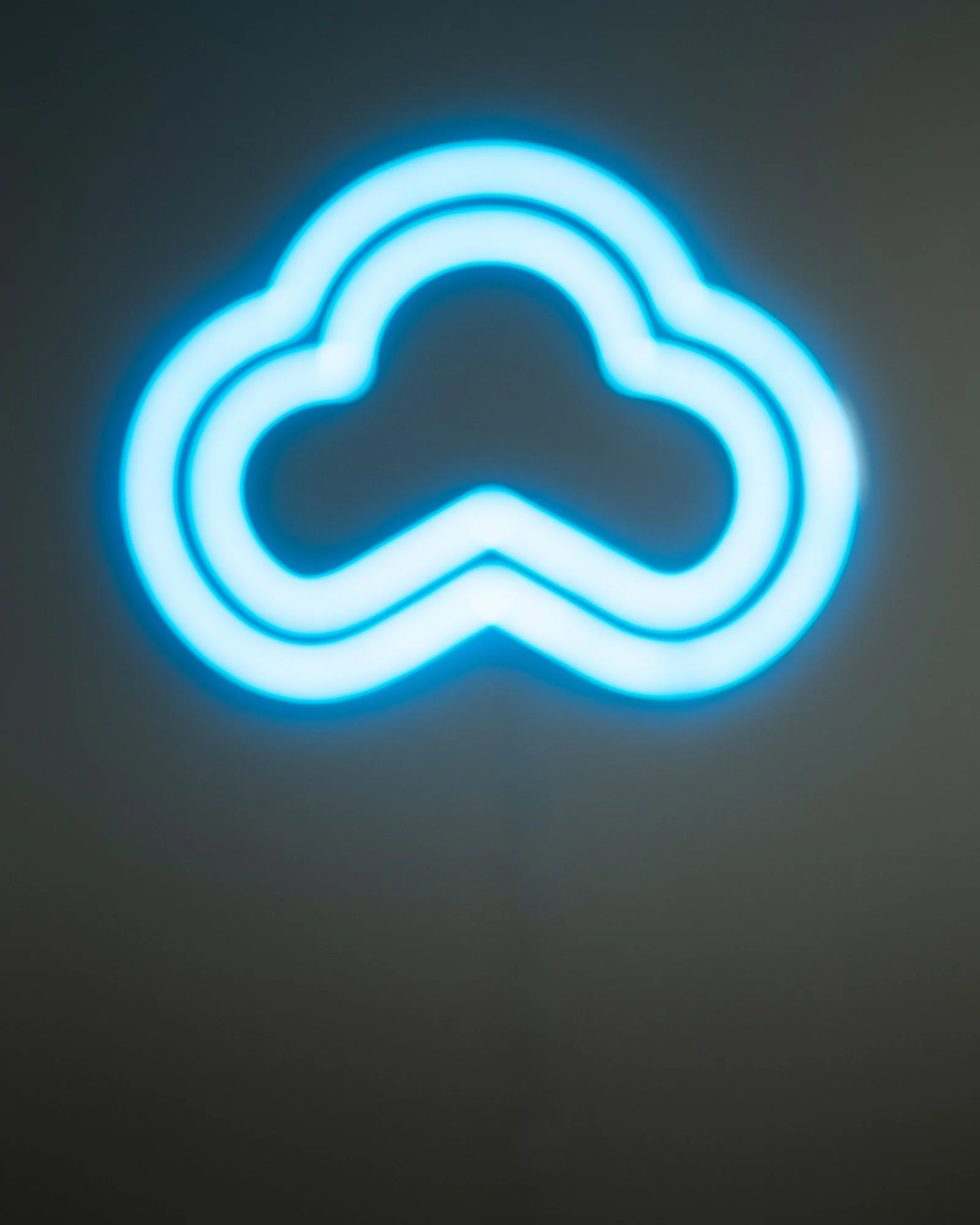 Blue neon cloud logo on dark background.