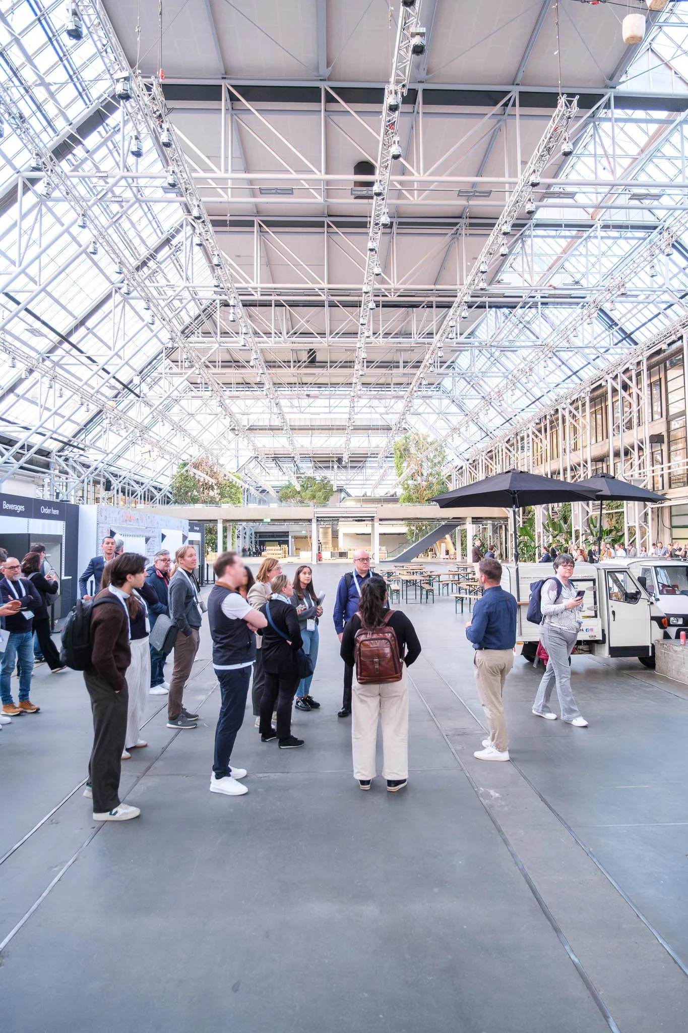 Conference delegates exploring Bella Center atrium on site tour at Illuminate EMEA 2026 — Copenhagen event photography Ballo Studio