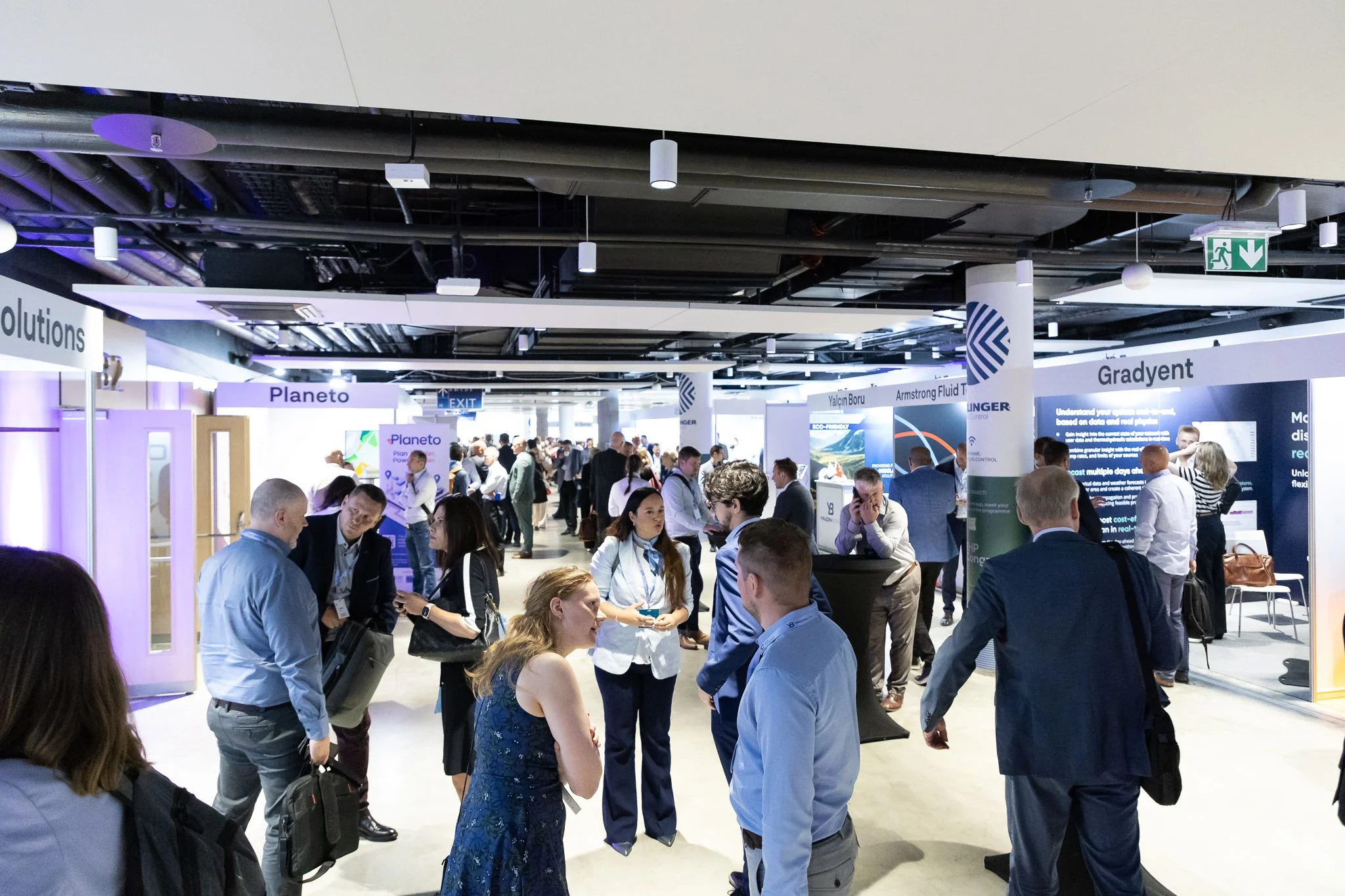 Attendees at Vaisala Xweather exhibition stand at Euroheat & Power Congress Amsterdam — corporate event photography Ballo Studio
