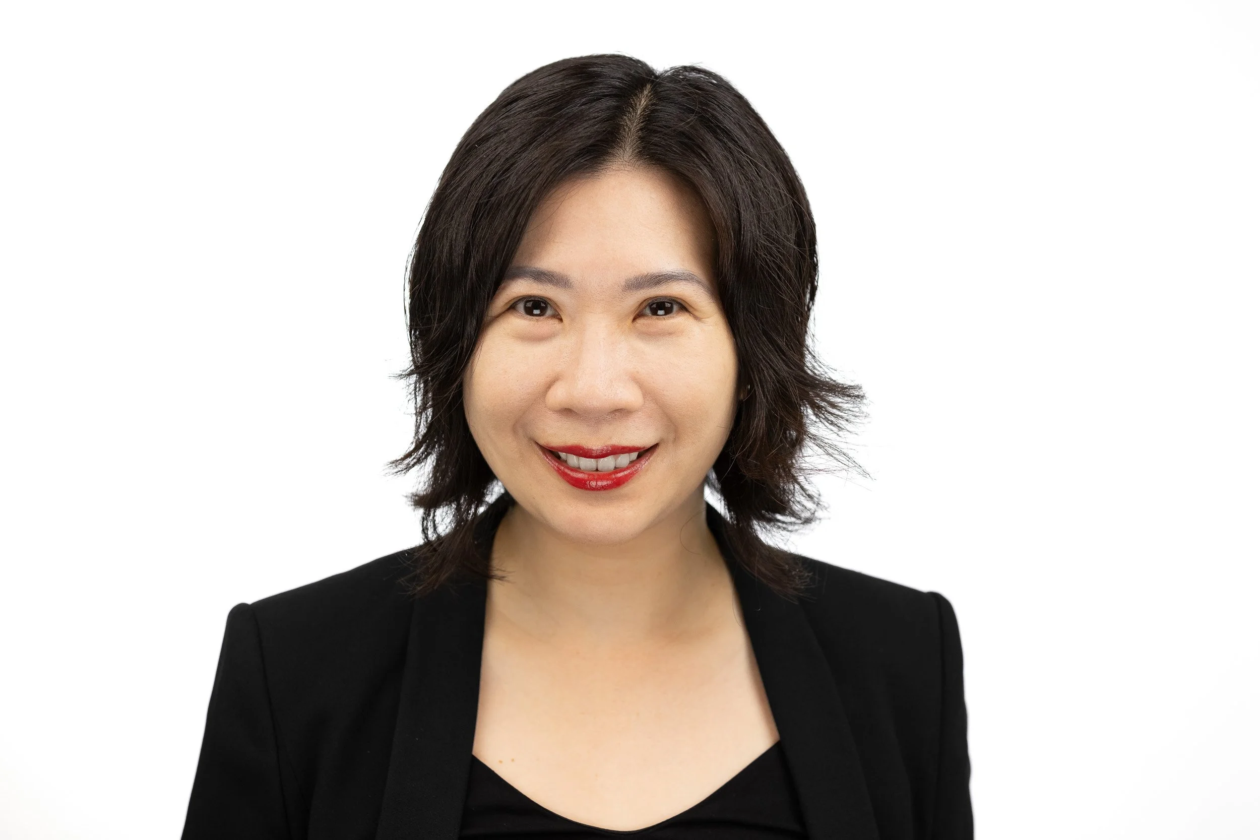 TCI Biotech employee headshot, woman with short dark hair and warm smile in black blazer — on-site headshot studio Amsterdam Ballo Studio