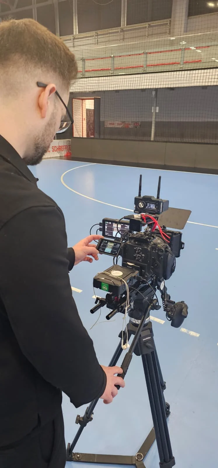 ASICS handball social media shoot videographer operating cinema camera on handball court Hungary — athlete content production Ballo Studio