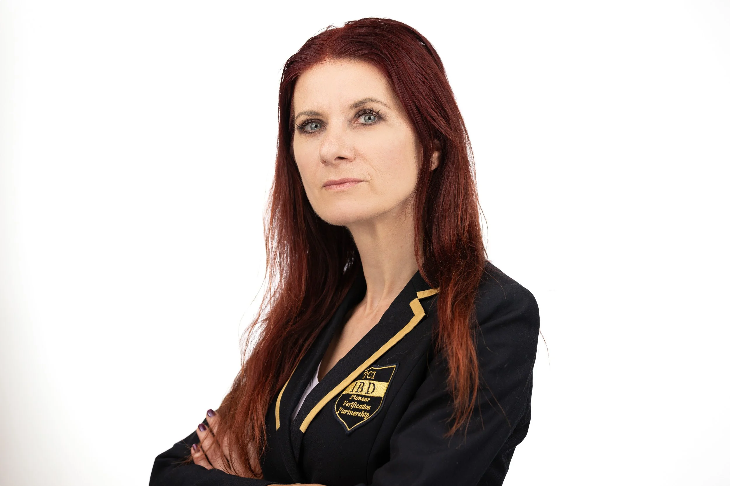 TCI Biotech employee headshot, woman with auburn hair in branded TCI IBD blazer, arms crossed — corporate headshot photographer Amsterdam Ballo Studio