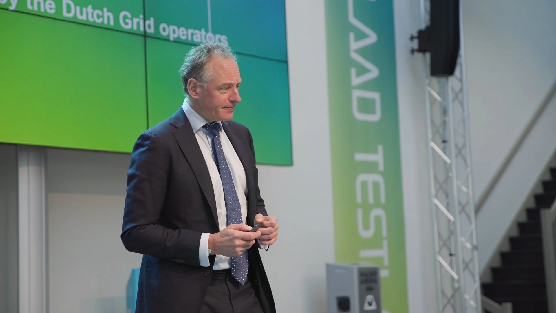 Speaker presenting on stage at PAIH Polish-Dutch Economic Mission conference on Dutch grid operators — event photographer Amsterdam Ballo Studio