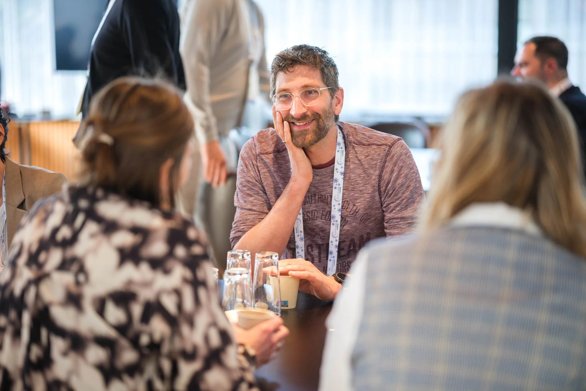 Attendees in conversation during networking break at Illuminate EMEA 2026 — Copenhagen event photography Ballo Studio