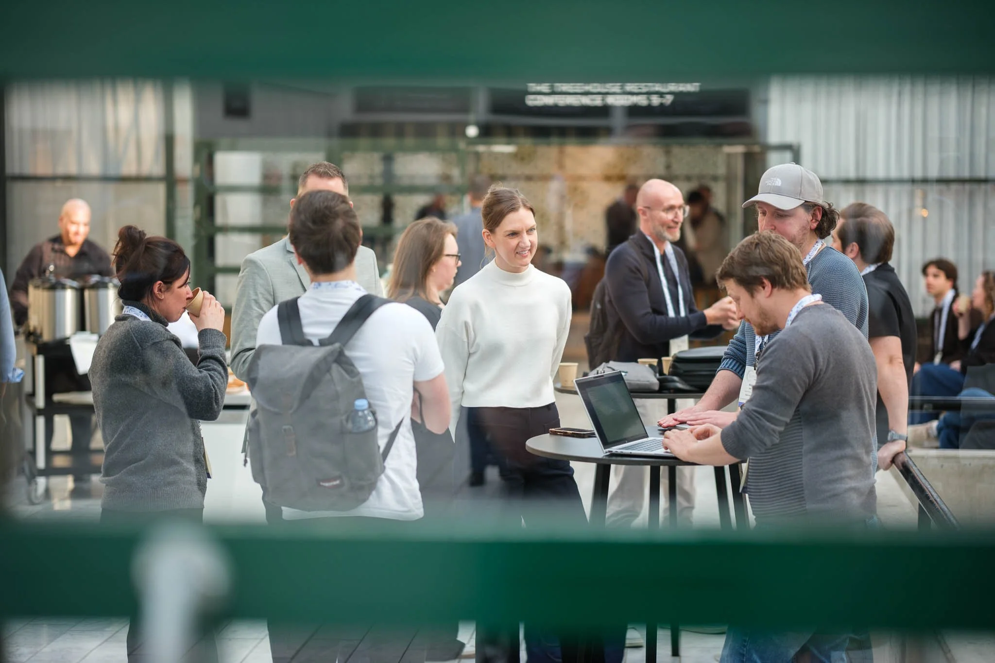 Delegates networking in venue atrium during break at Illuminate EMEA 2026 — Copenhagen event photography Ballo Studio