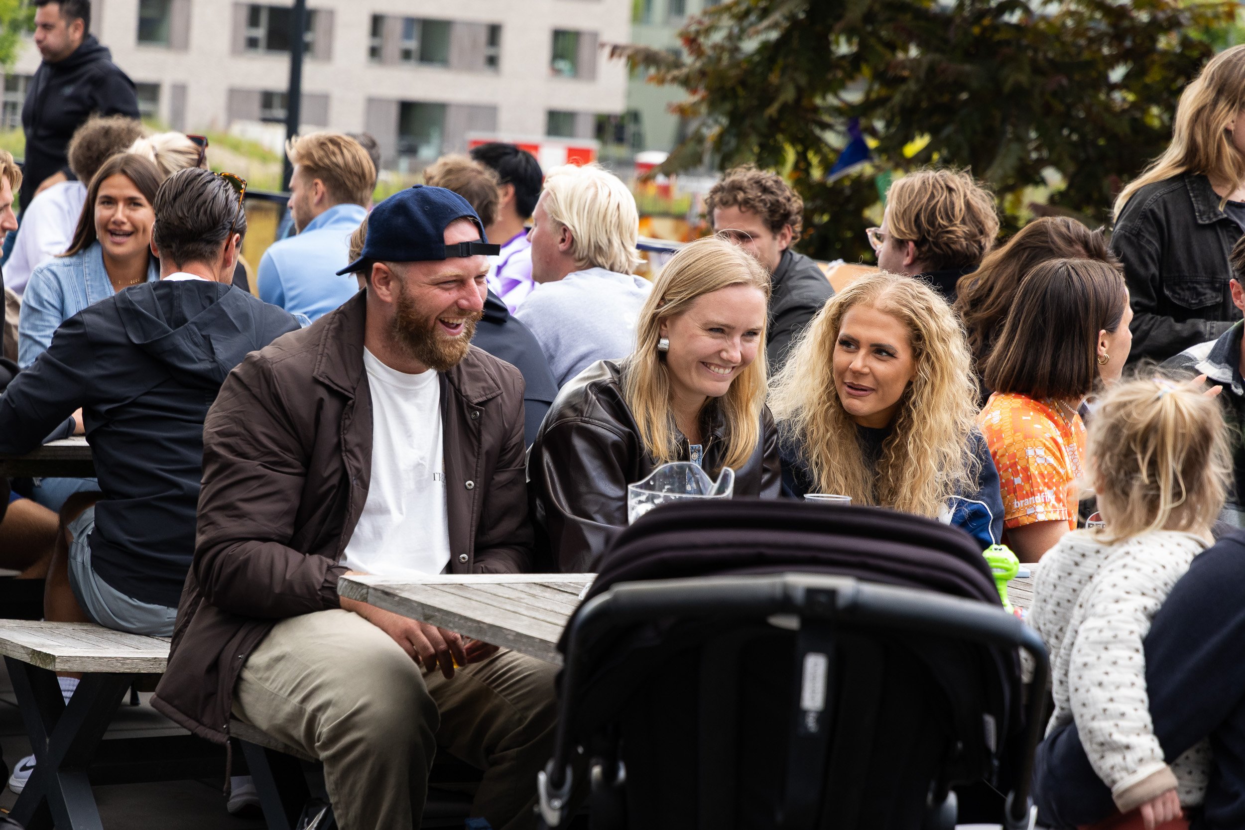 Spectators and families relaxing at outdoor social area during Adfocup 2026 advertising industry football tournament Amsterdam — corporate event photography Amsterdam Ballo Studio