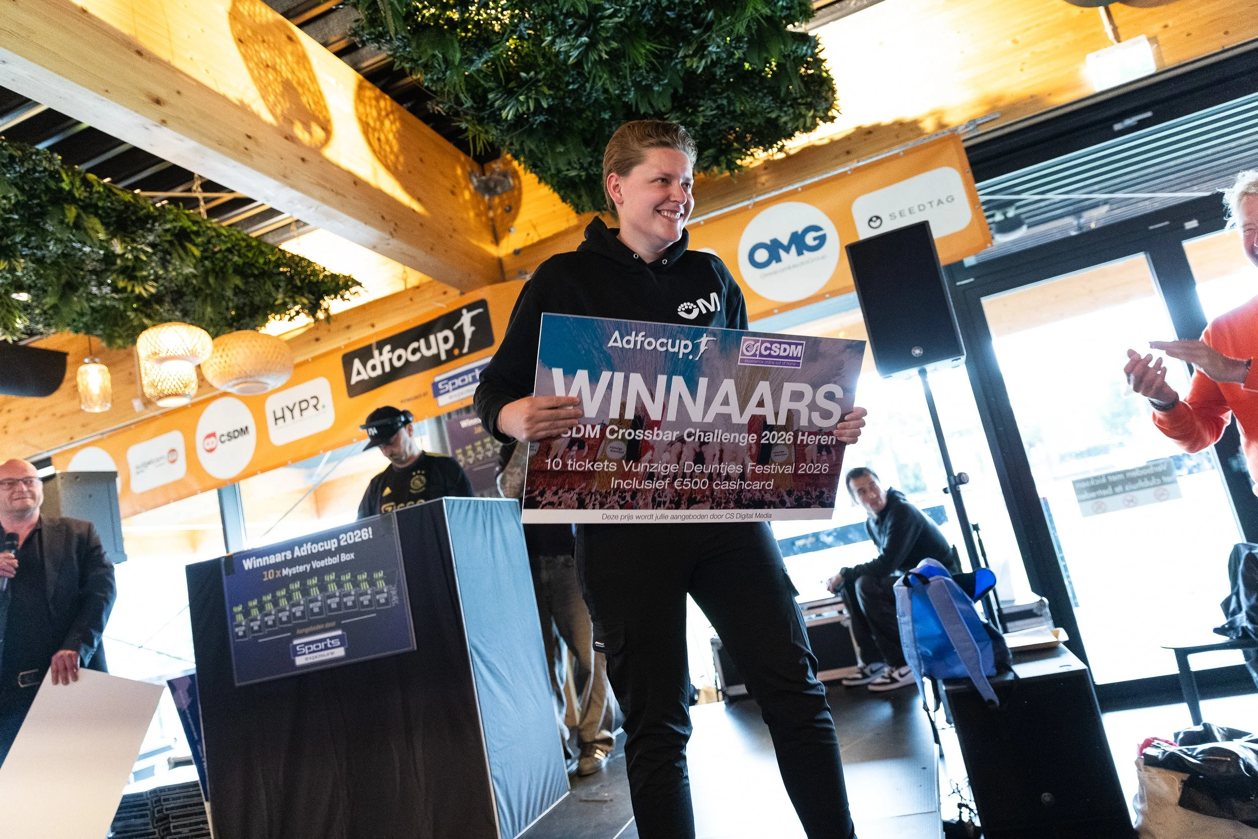OMG team winner holding Adfocup 2026 CSDM Crossbar Challenge winners banner at prize ceremony Amsterdam — corporate event photography Amsterdam Ballo Studio