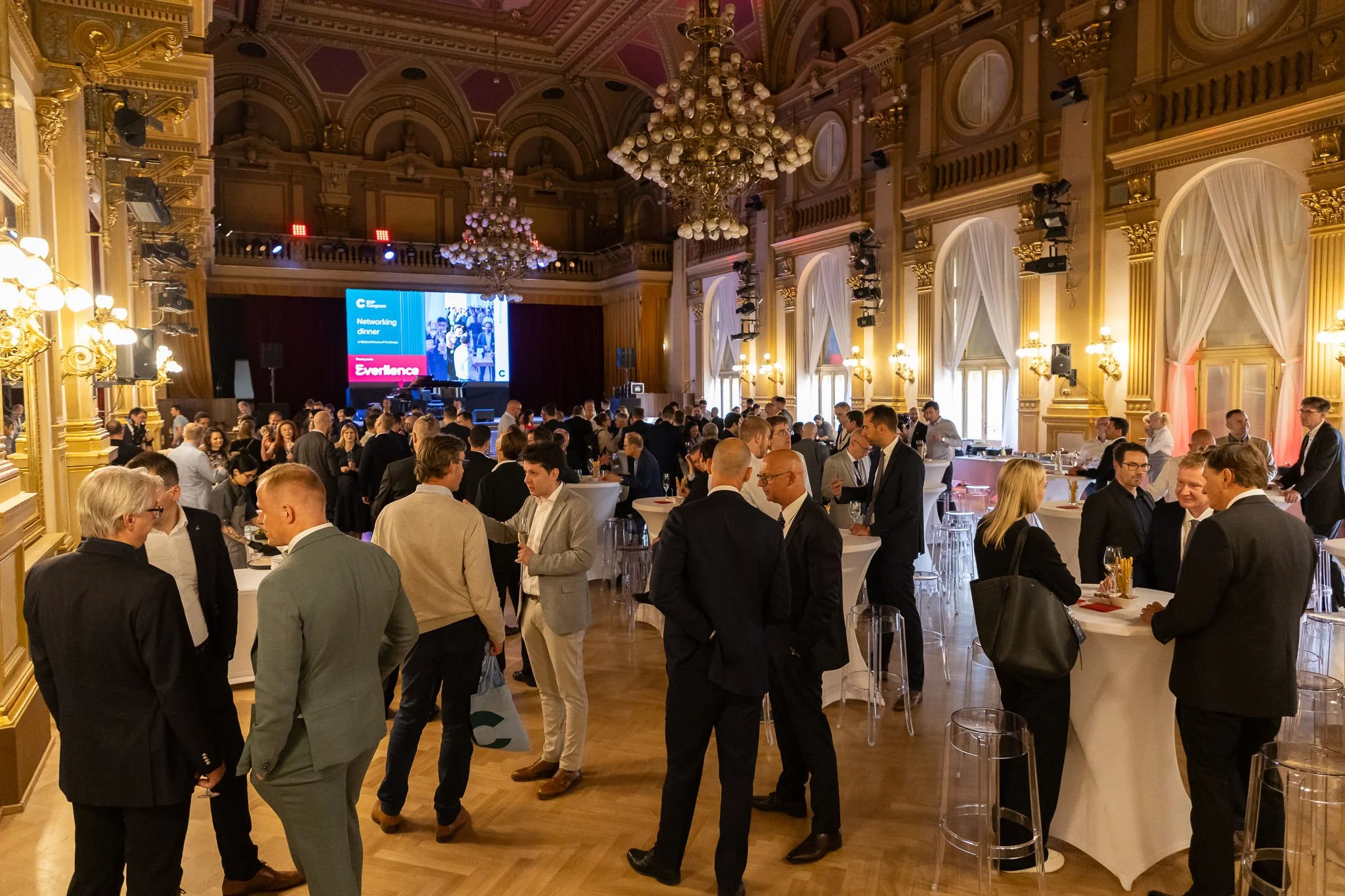 Evening networking reception with attendees in grand ornate venue at Euroheat & Power Congress Amsterdam — event photography Amsterdam Ballo Studio