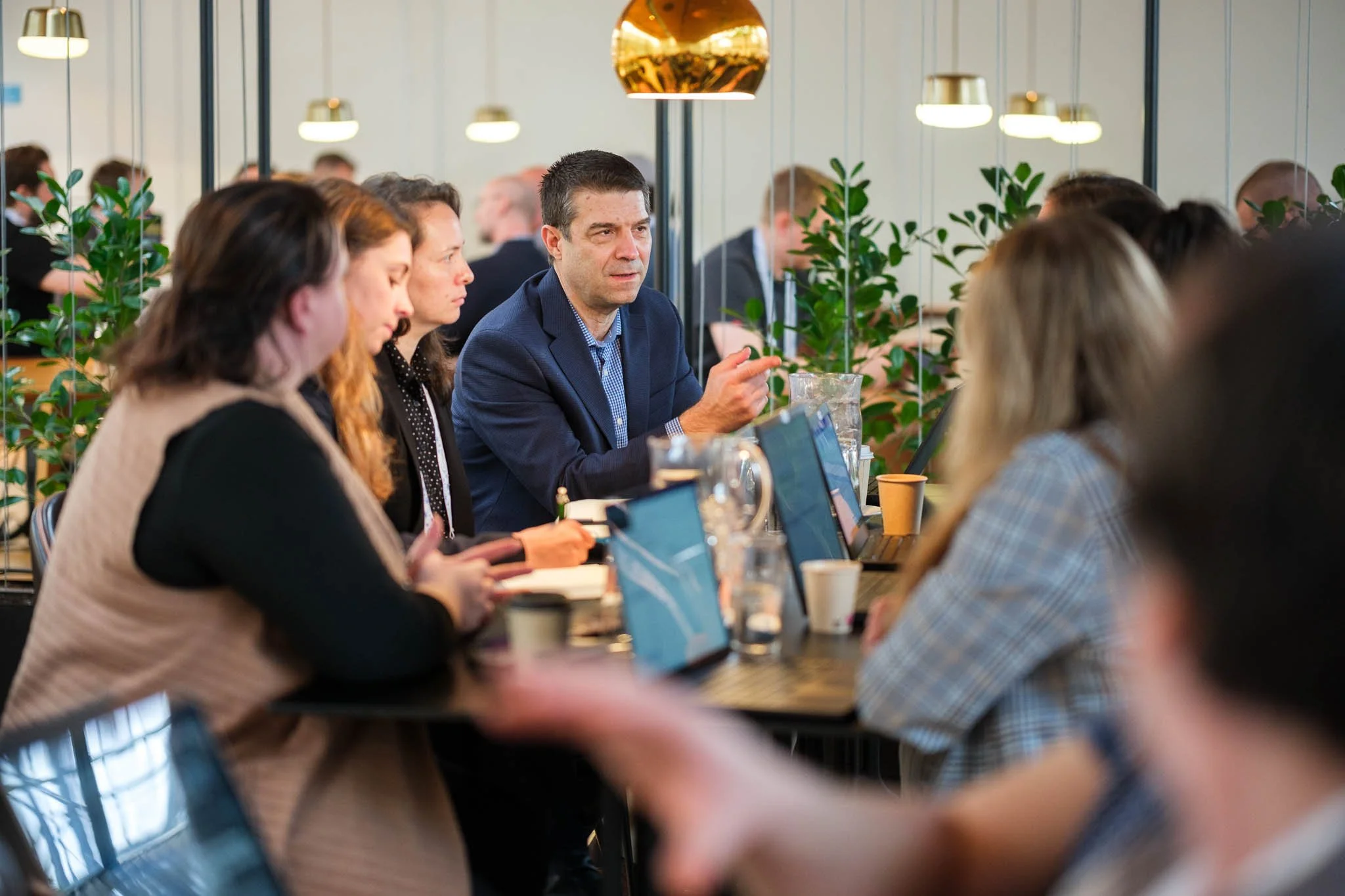 Delegates engaged in group discussion at workshop table at Illuminate EMEA 2026 — Copenhagen conference photography Ballo Studio