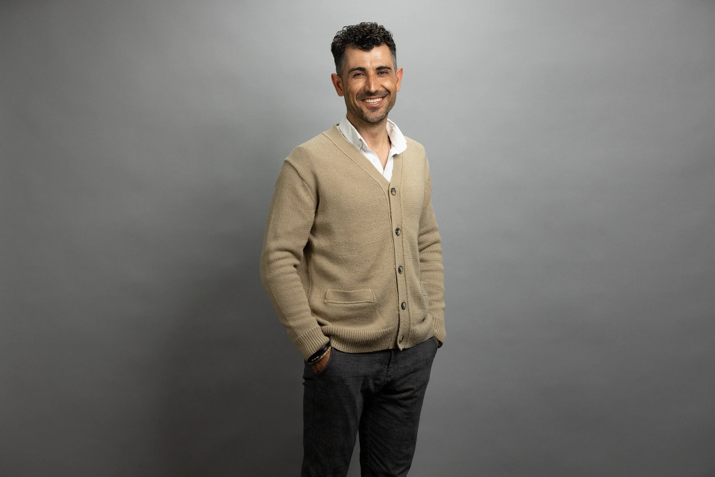 EPEX SPOT employee portrait, smiling woman in cream turtleneck and black wide-leg trousers — corporate headshot photographer Amsterdam Ballo Studio