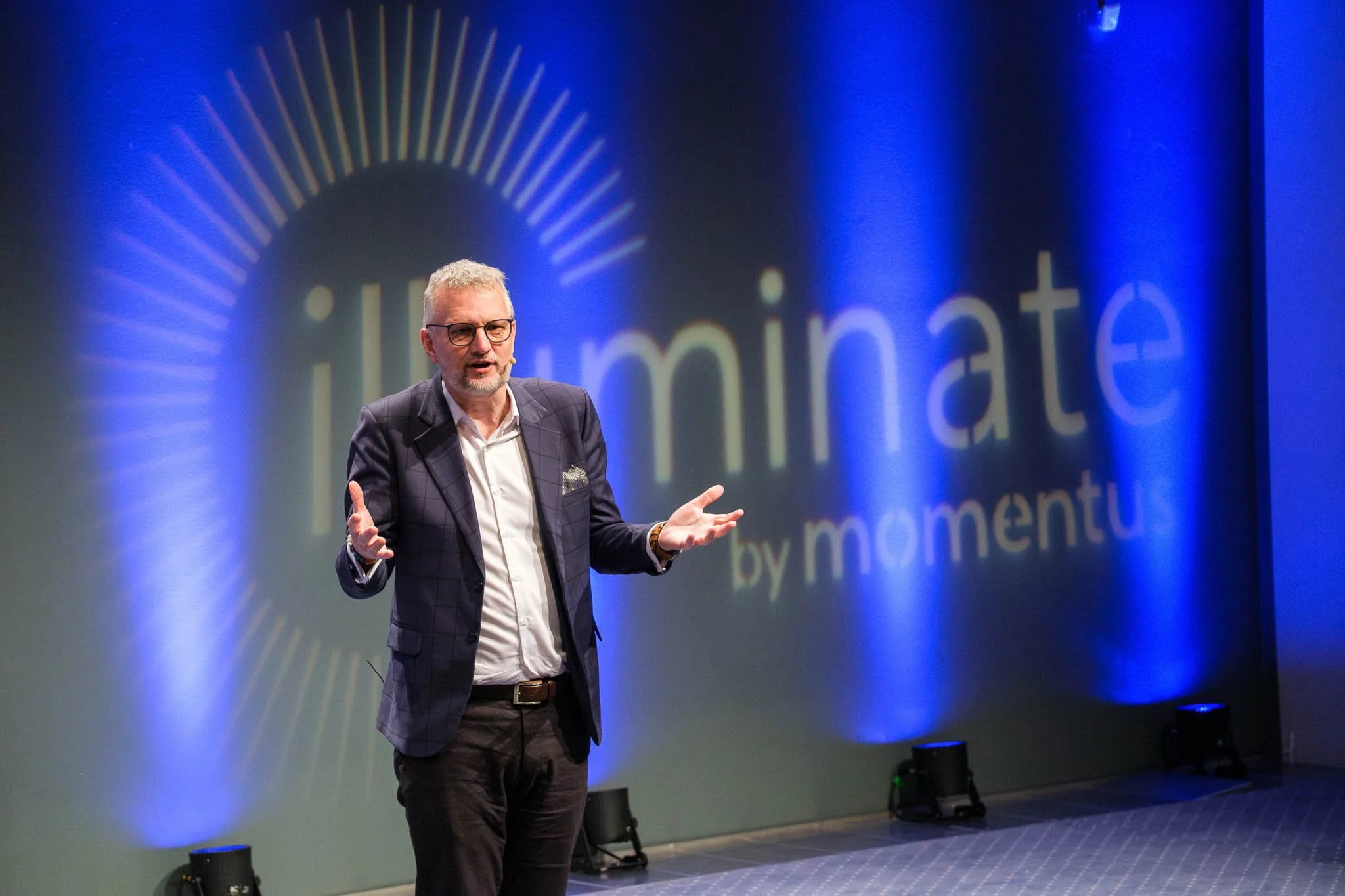 Full stage shot with speaker at Illuminate EMEA 2026 — Copenhagen event photography Ballo Studio