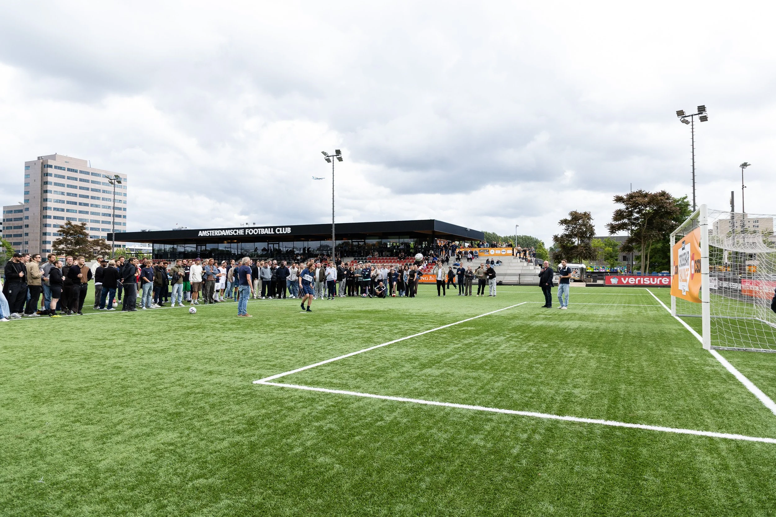 Wide view of Amsterdamsche Football Club grounds with crowd gathered for Adfocup 2026 tournament activities Amsterdam — event photographer Amsterdam Ballo Studio