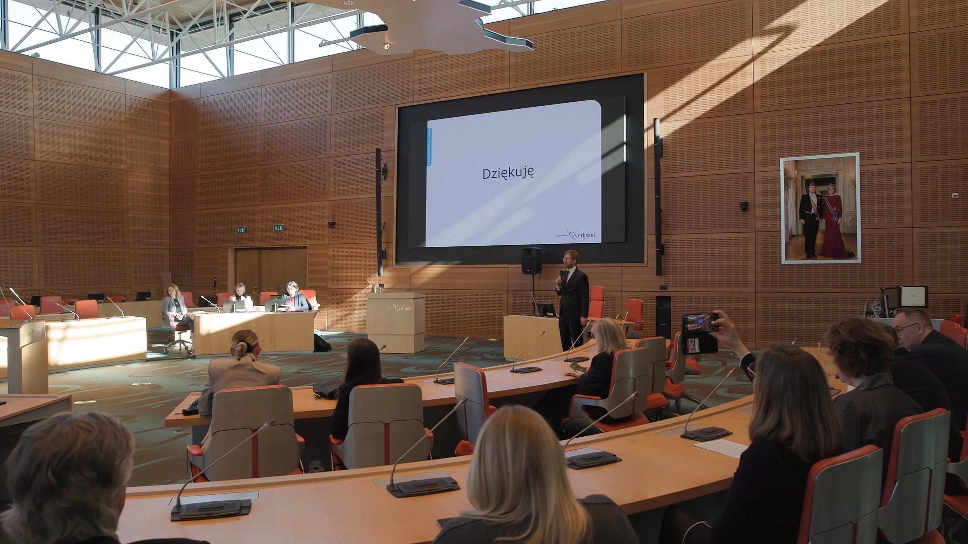 Speaker presenting in formal chamber at PAIH Polish-Dutch Economic Mission official conference session — event photography Amsterdam Ballo Studio