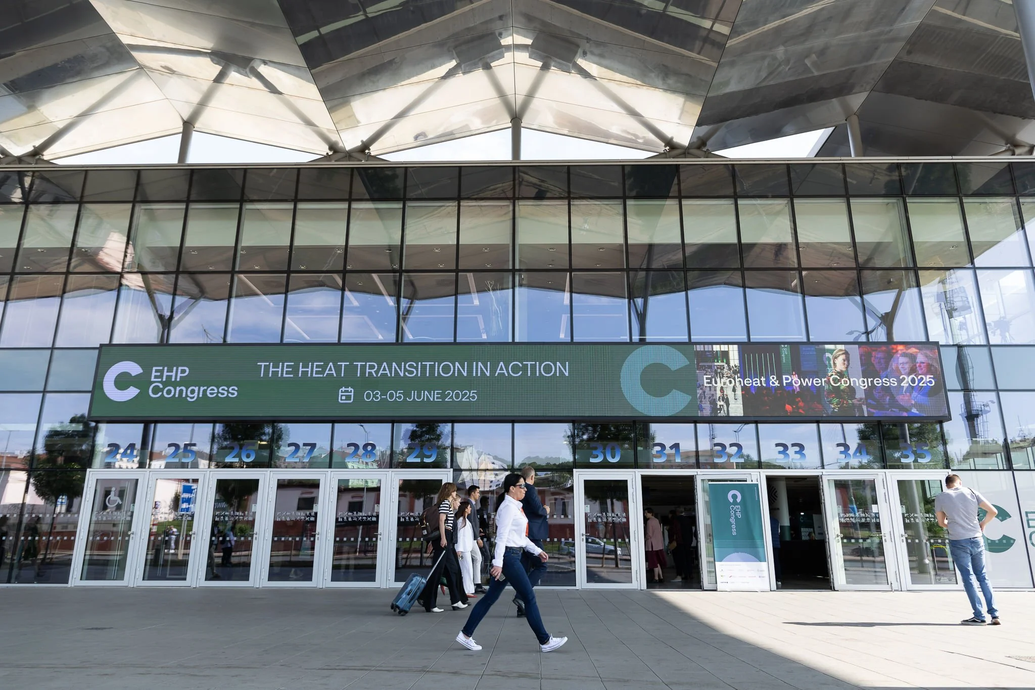 Exterior of EHP Congress 2025 venue with The Heat Transition in Action banner and arriving attendees in Amsterdam — conference photographer Amsterdam Ballo Studio