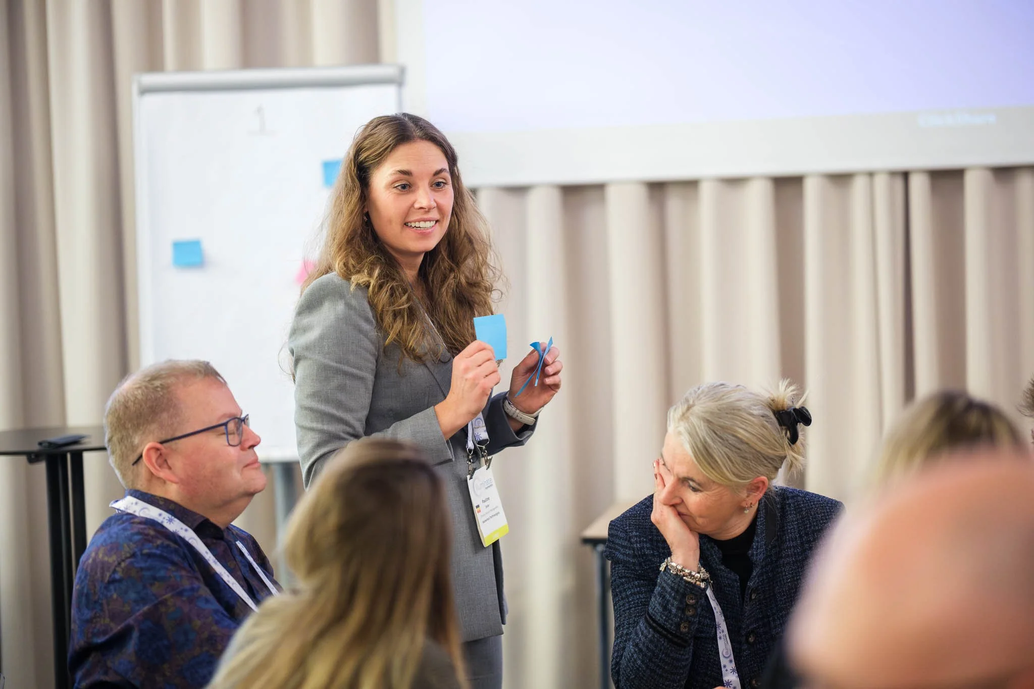 Workshop facilitator presenting ideas with sticky notes to seated delegates at Illuminate EMEA 2026 — Copenhagen conference photography Ballo Studio