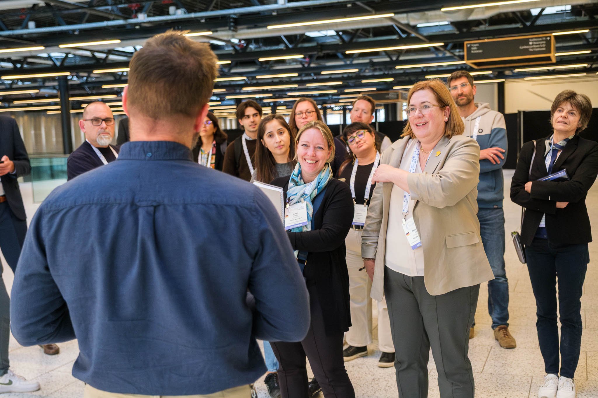 Delegates listening to tour guide at Bella Center site tour during Illuminate EMEA 2026 — Copenhagen conference photography Ballo Studio