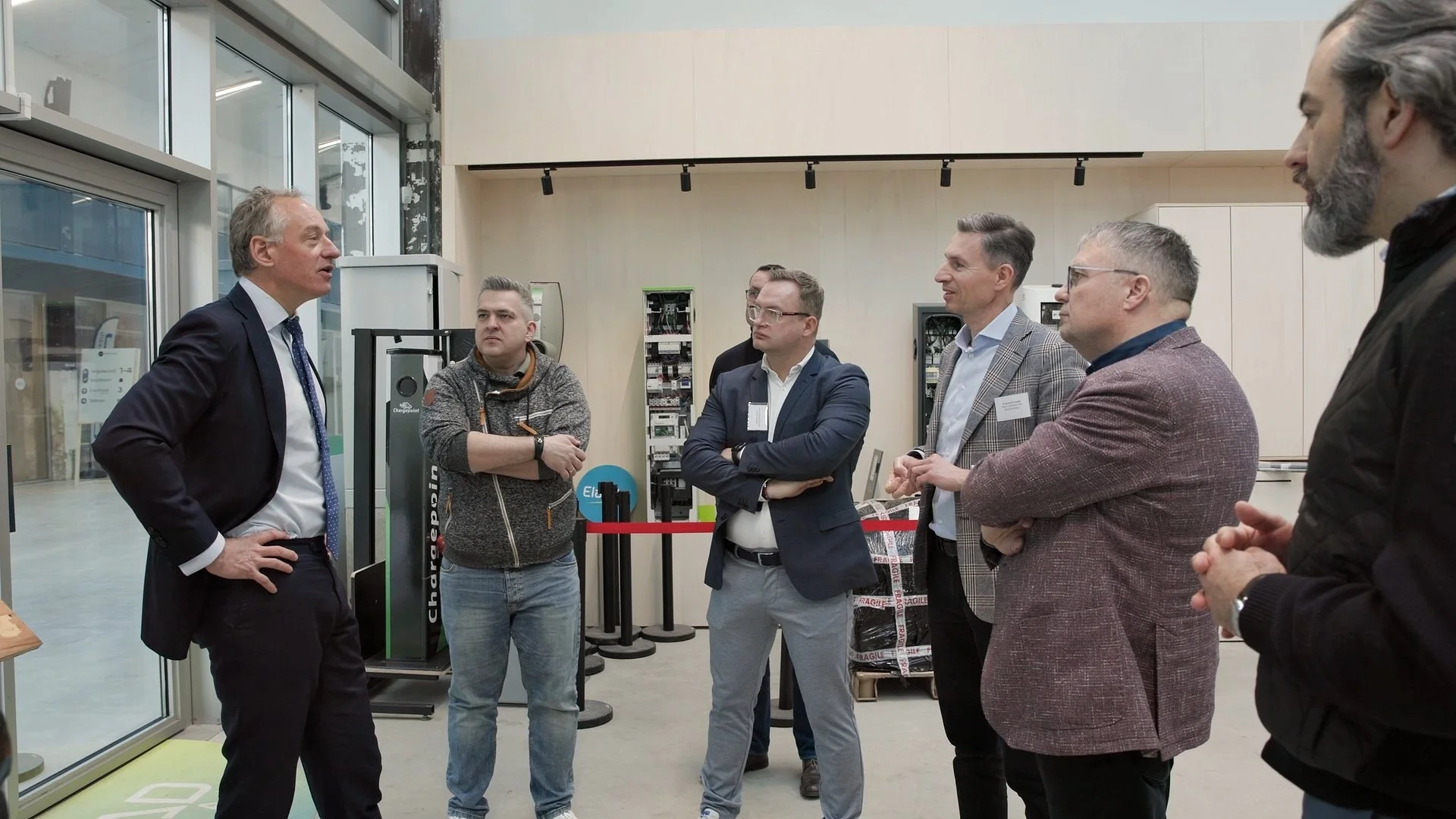 Business delegates networking during PAIH Polish-Dutch Economic Mission facility visit — corporate event photography Amsterdam Ballo Studio
