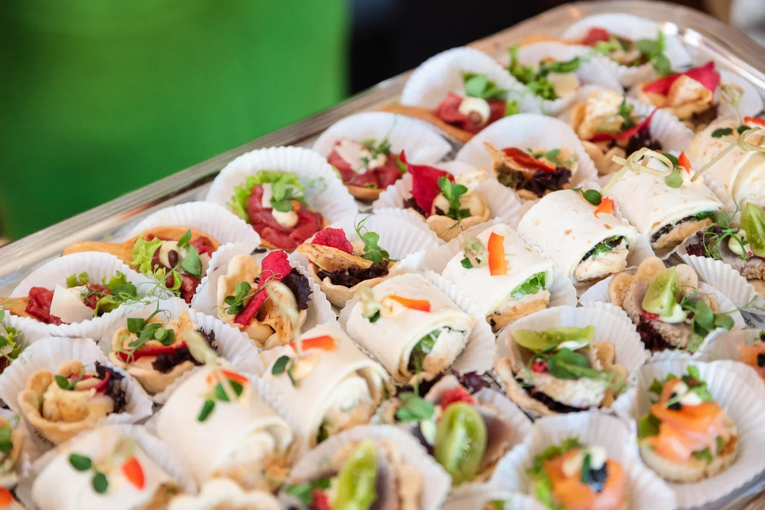 Assorted small sandwiches and appetizers on a tray