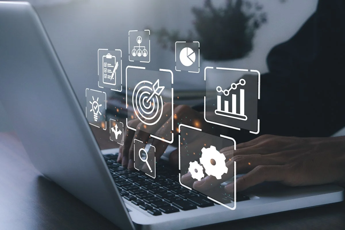Person using a laptop with various digital icons overlayed, including target, chart, magnifying glass, gears, and checklists, representing data analysis or digital tools.