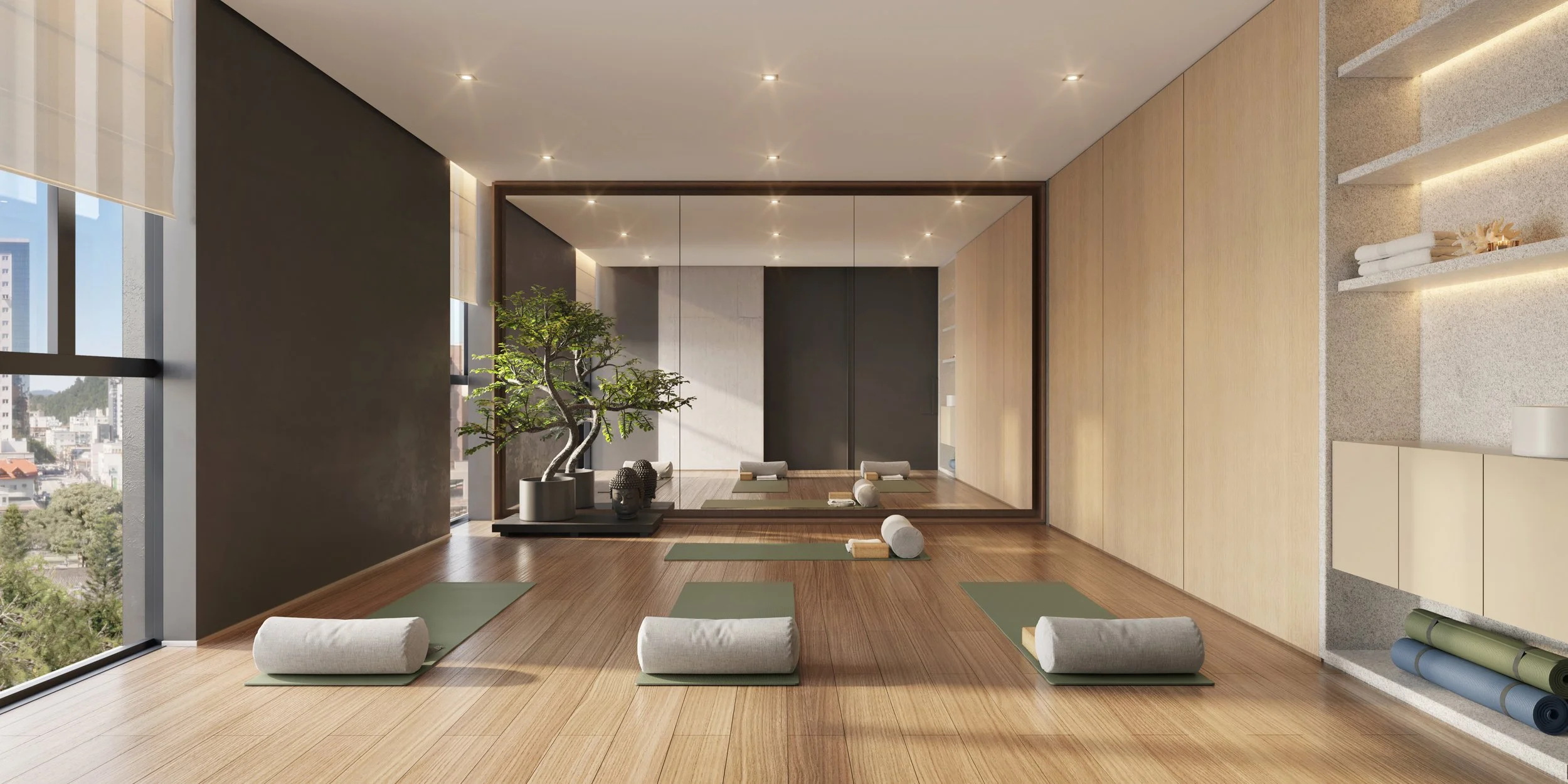 Sala de yoga com tapetes, almofadas, rolos e janelas grandes, decorada com plantas e iluminação suave.