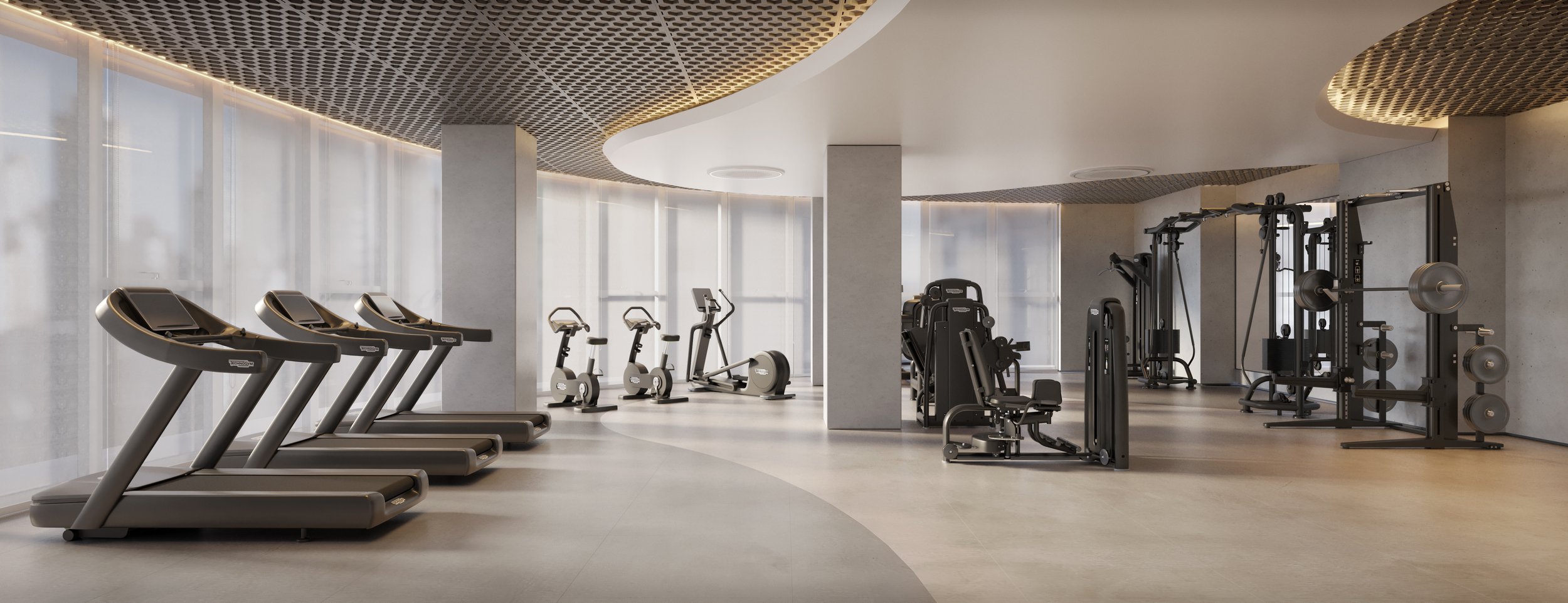 Sala de ginástica com esteiras, bicicletas ergométricas, aparelho de musculação e pesos em ambiente bem iluminado e moderno.