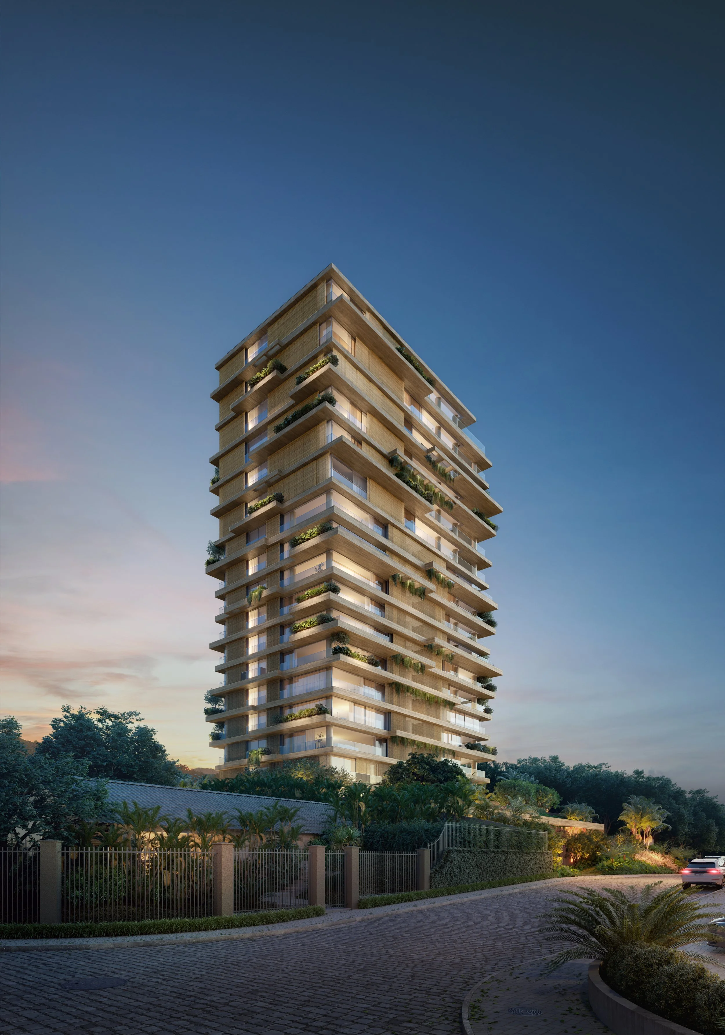 Edifício residencial em Joinville com arquitetura assinada, moderno com varanda com plantas, iluminação externa, cercado por vegetação, ao entardecer.