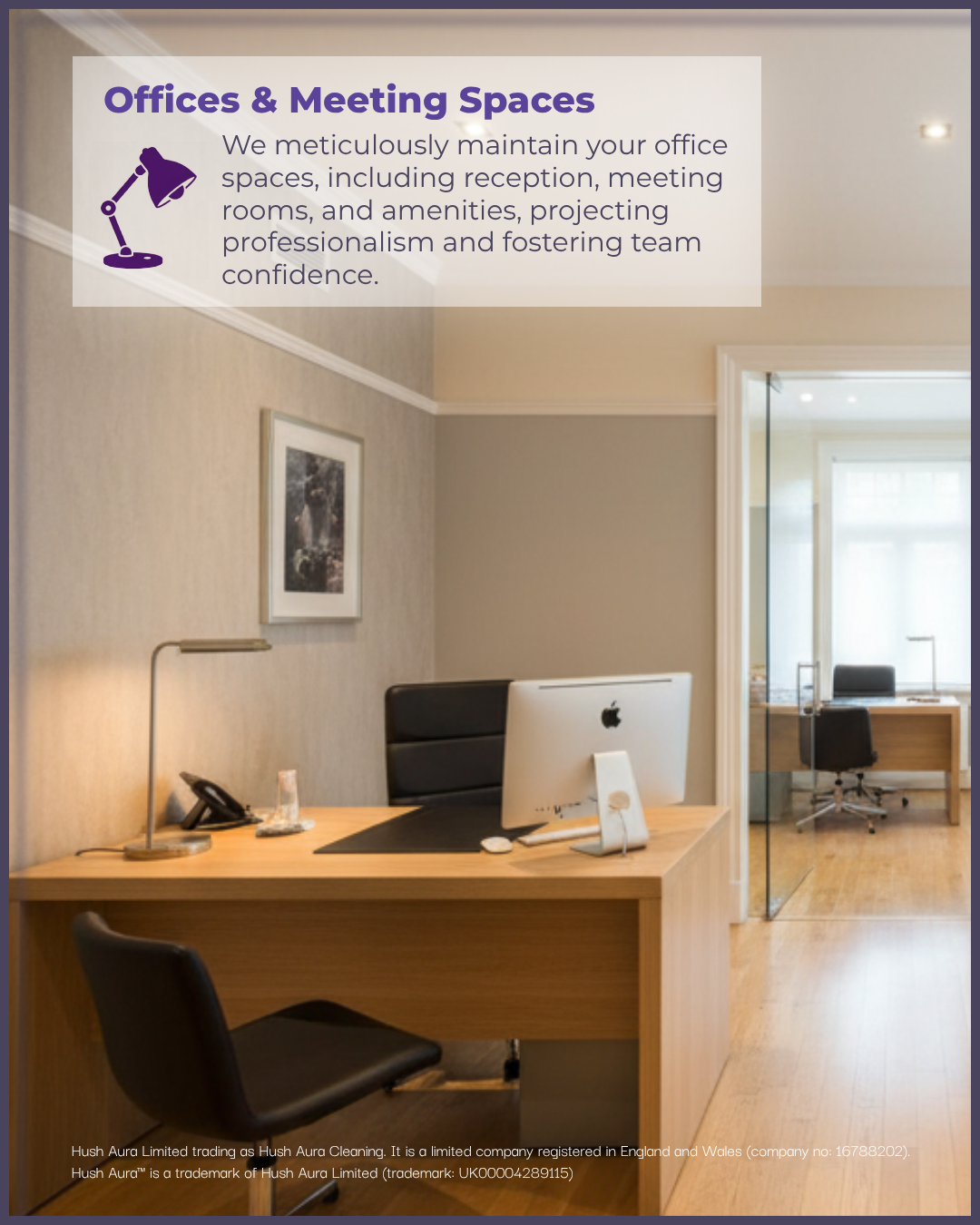An office with a wooden desk, computer, telephone, and black office chair, with a picture frame on the wall and a glass door leading to another room with a similar office setup. A sign with office and meeting space information is posted on the wall.