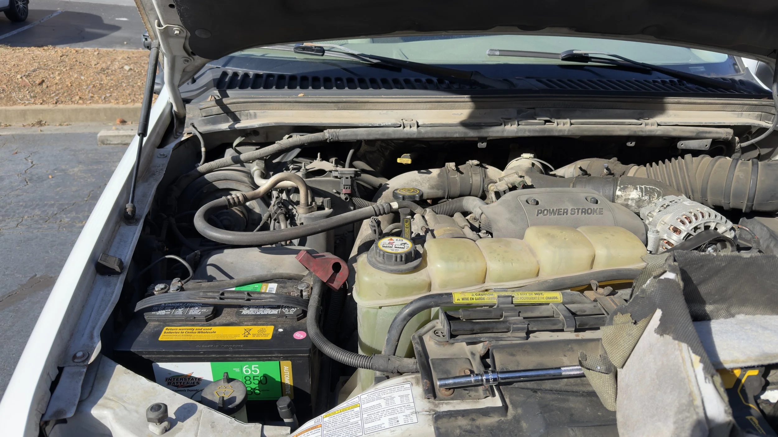Ford 7.3L Powerstroke engine bay during on-site mobile repair by ALP Enterprises