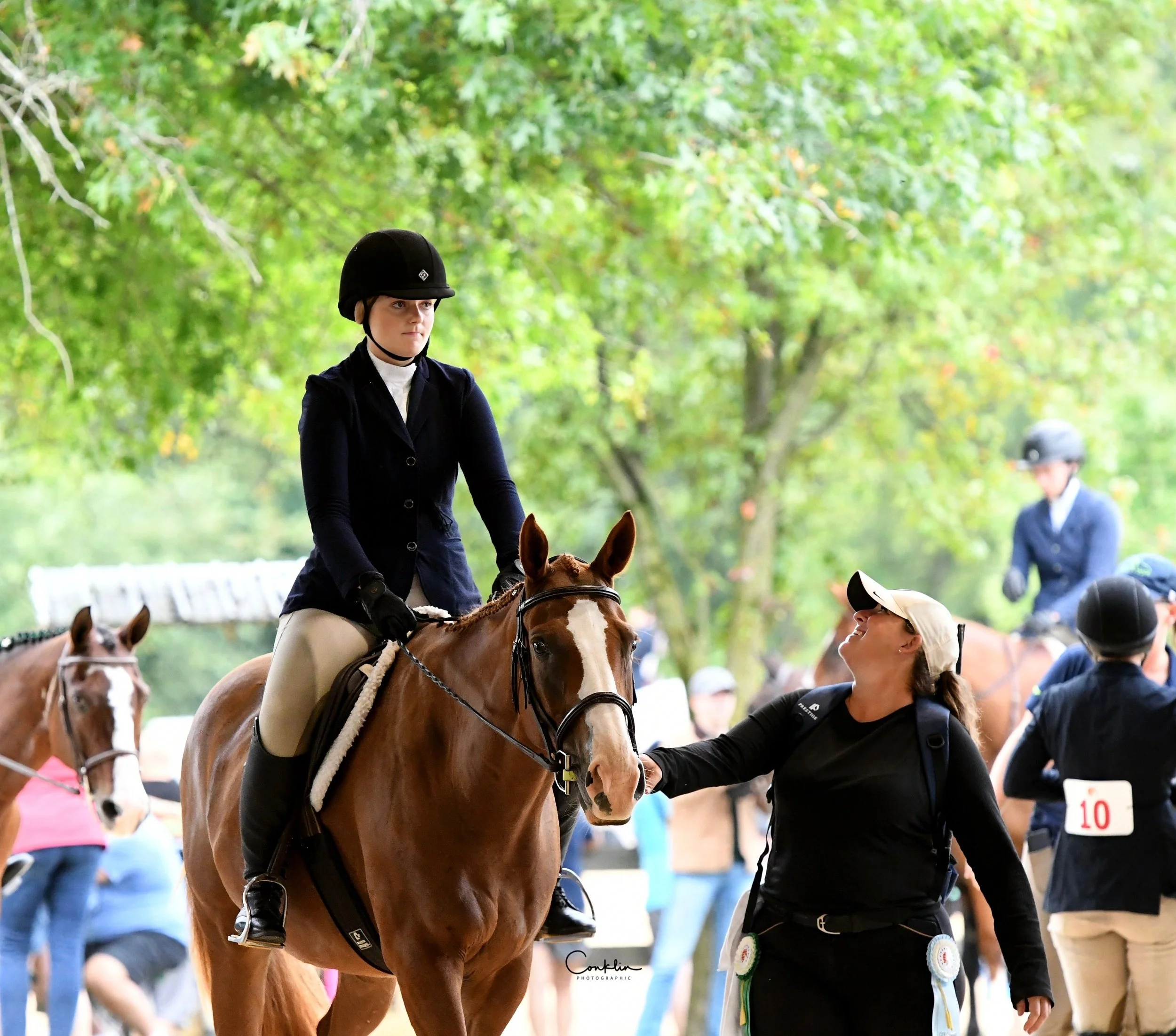riding instructor and student at horse show