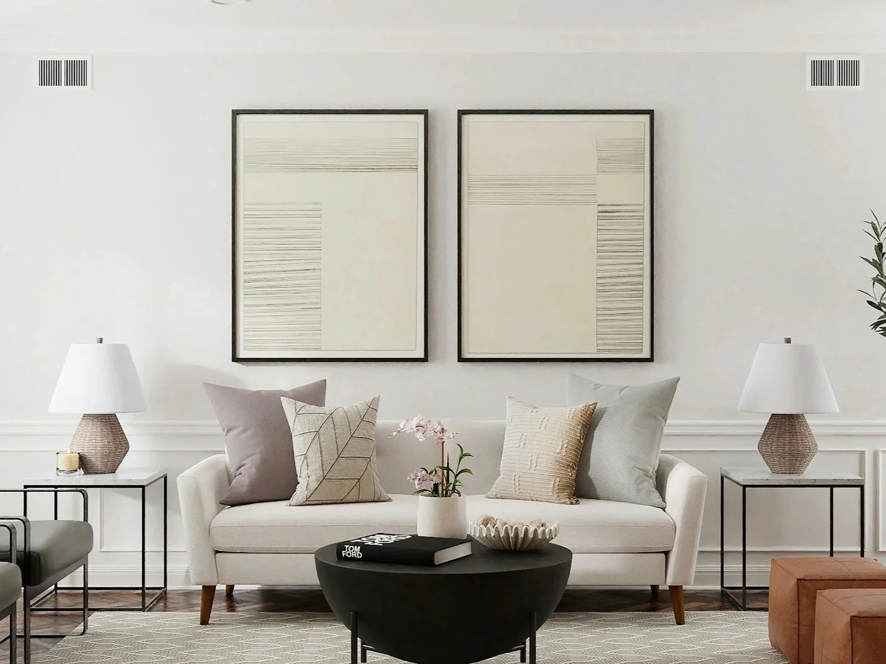 Living room with white walls, cream sofa, black armchairs, side tables with lamps, framed art on wall, and a window with white curtains.
