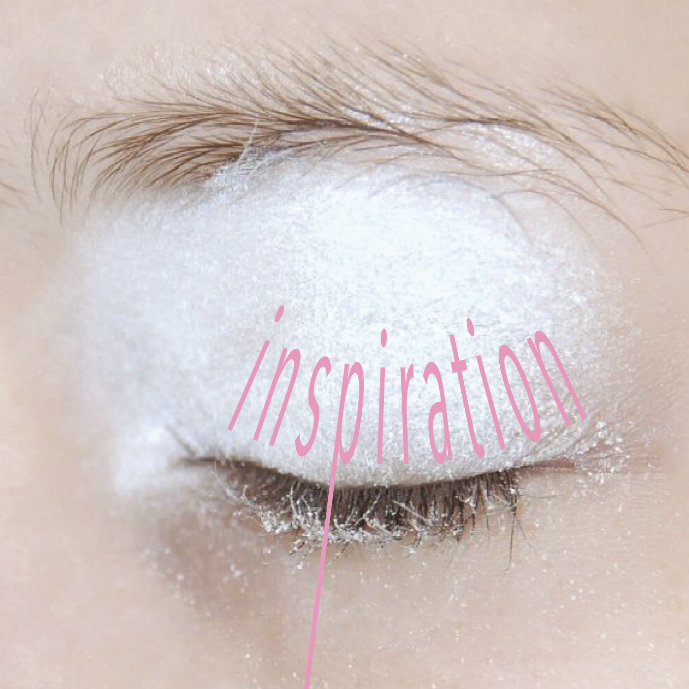 Close-up of a closed eye with white makeup, with the word 'inspiration' written in pink across the eyelid.