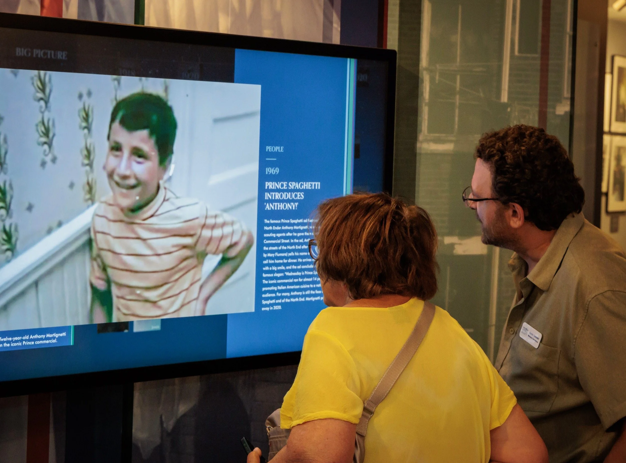 Visitors watching a North End family story on one of the interactive screens.