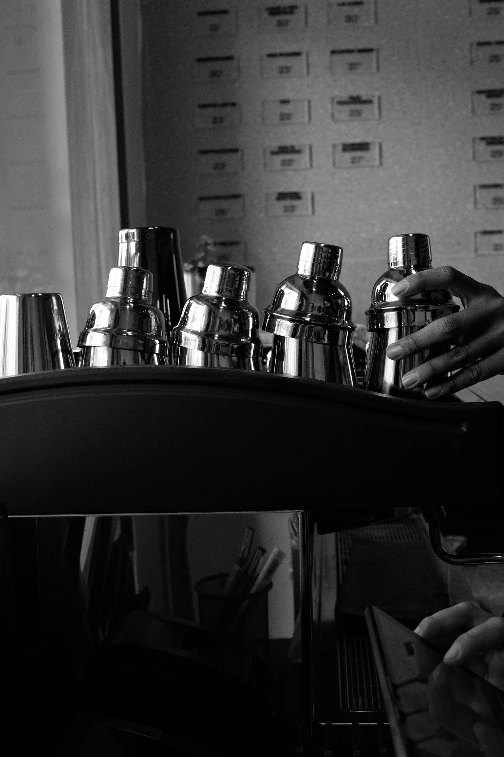 Bartender preparing cocktails using professional bar tools at a Dolly's Occasions mobile bar.