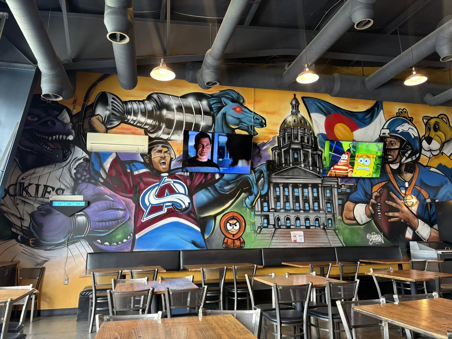 Large-scale mural with Denver icons such as Colorado Avalance, Denver Broncos, Colorado Rockies, Blucifer.