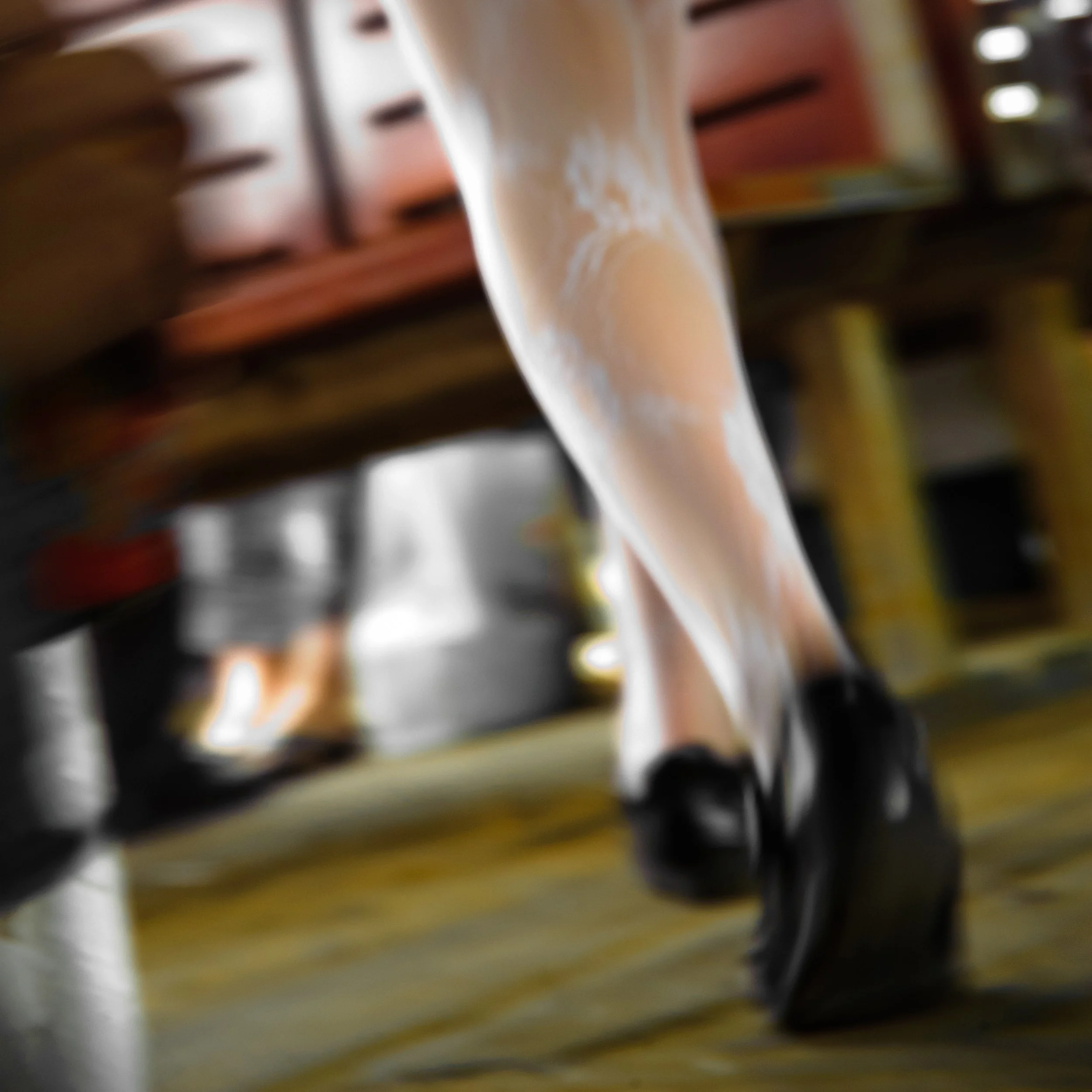 Close-up of a person's leg in a white stocking and black shoe stepping on a yellow surface in a workshop setting